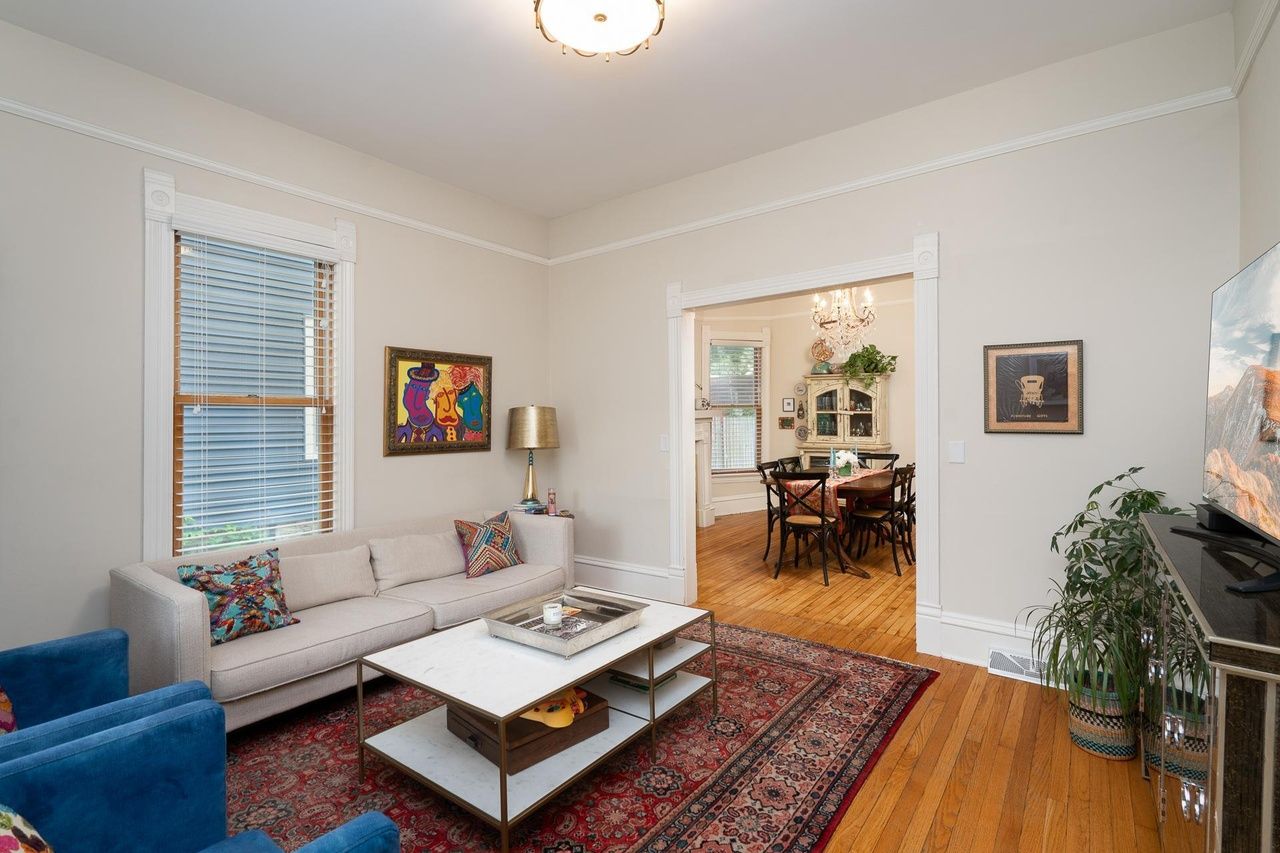 living room with view of dining room in background