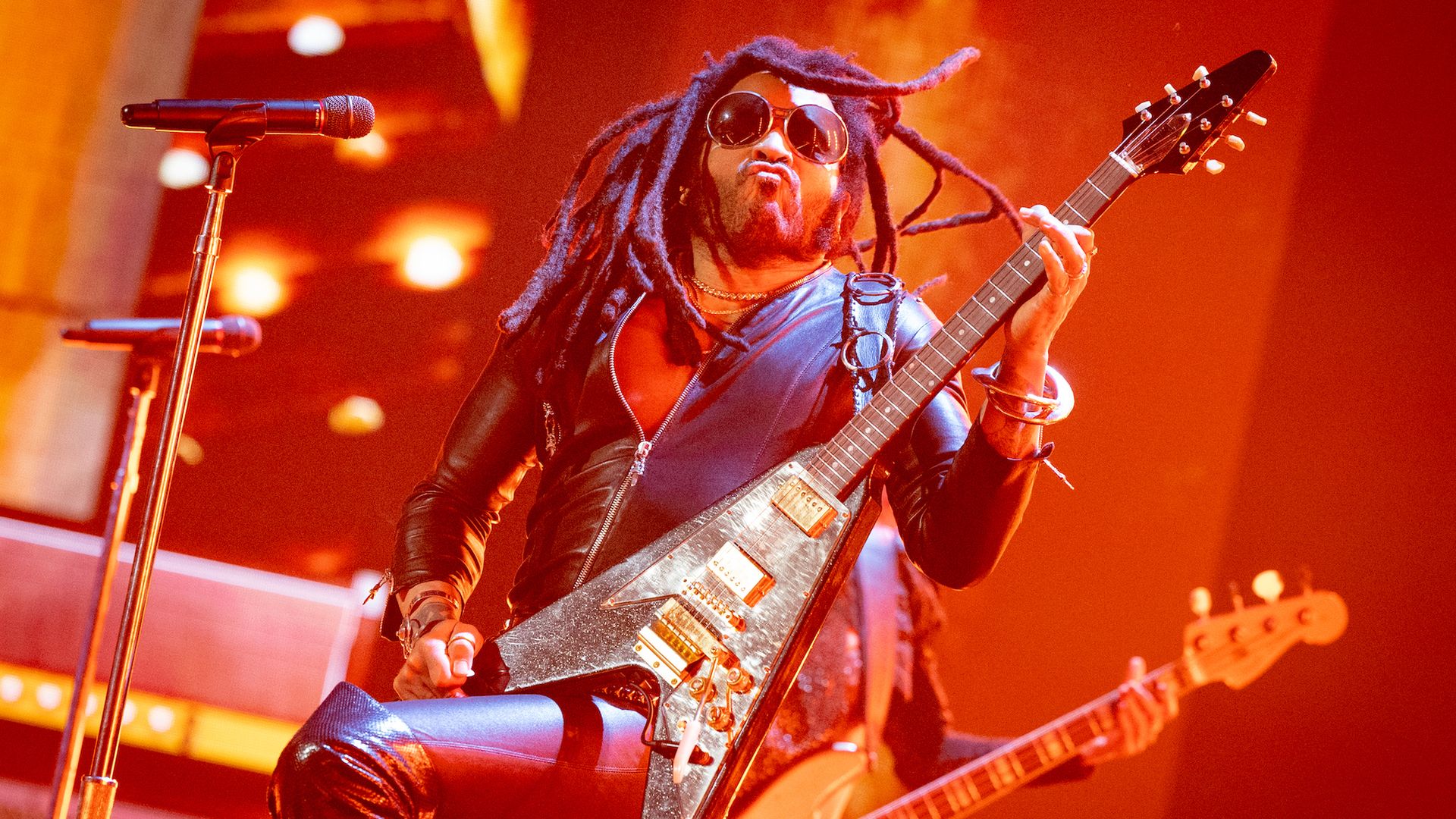 Lenny Kravitz performs on stage. 