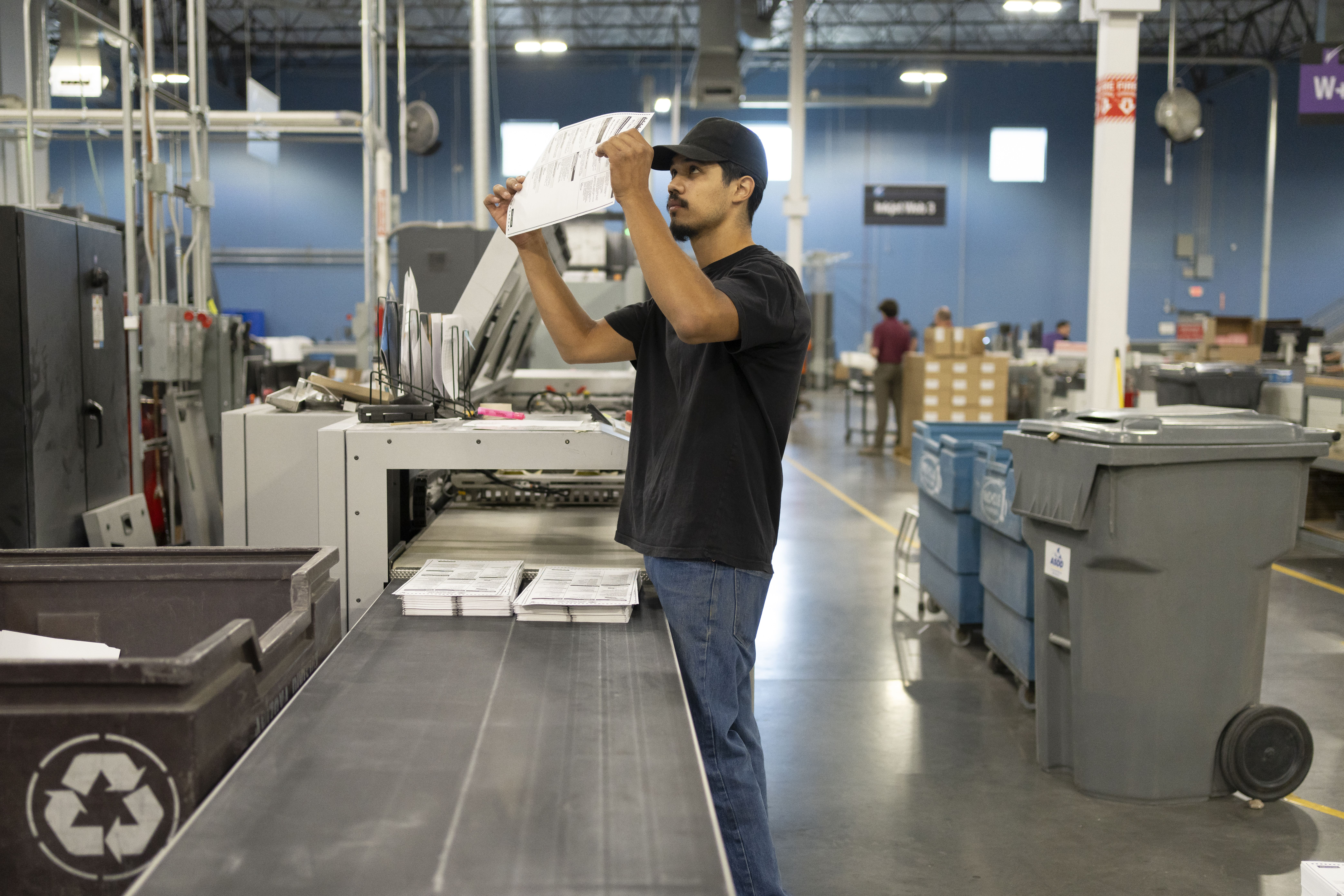 A man inspecting a ballot. 