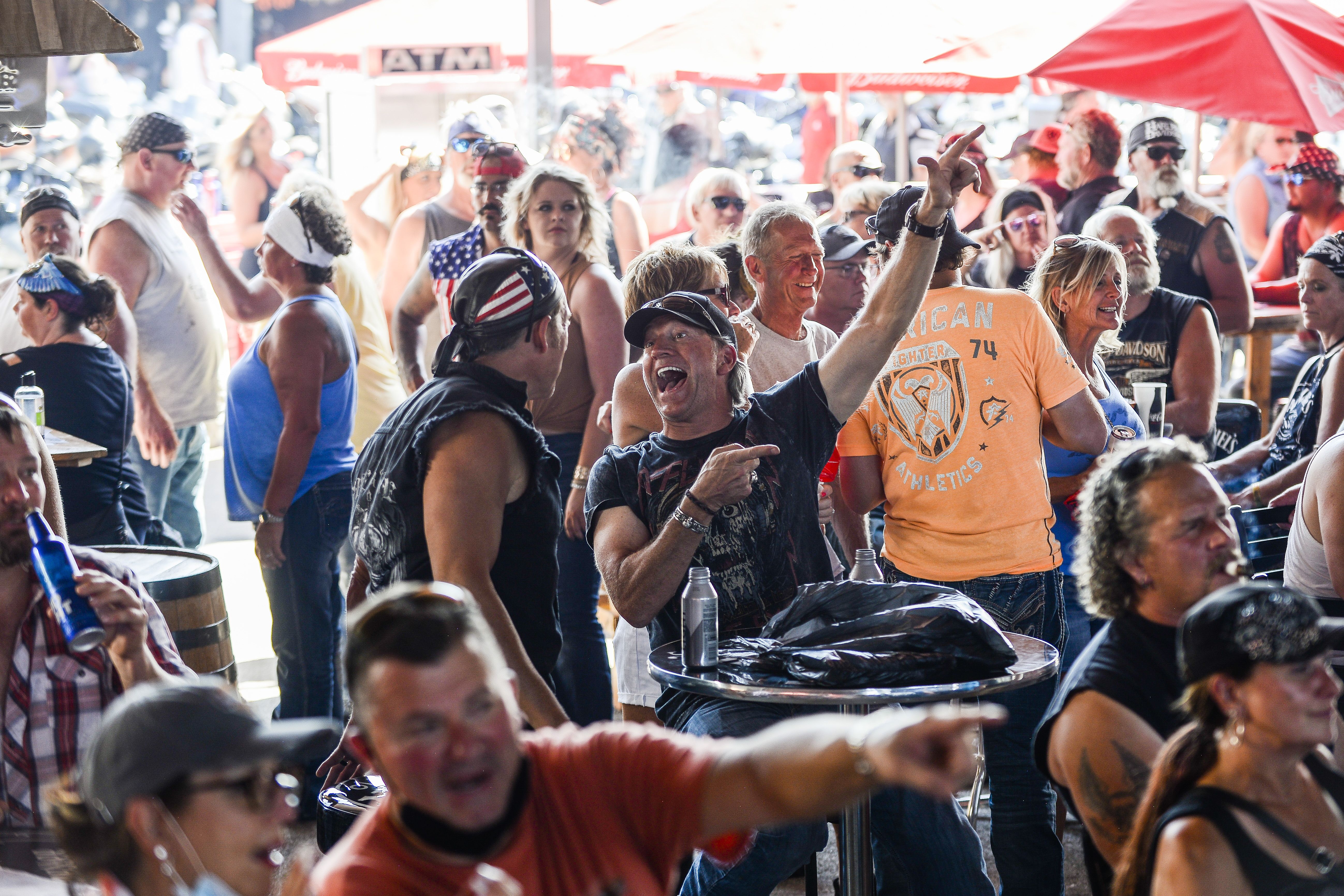 People cheering while watching a band perform in Sturgis on Aug. 7.
