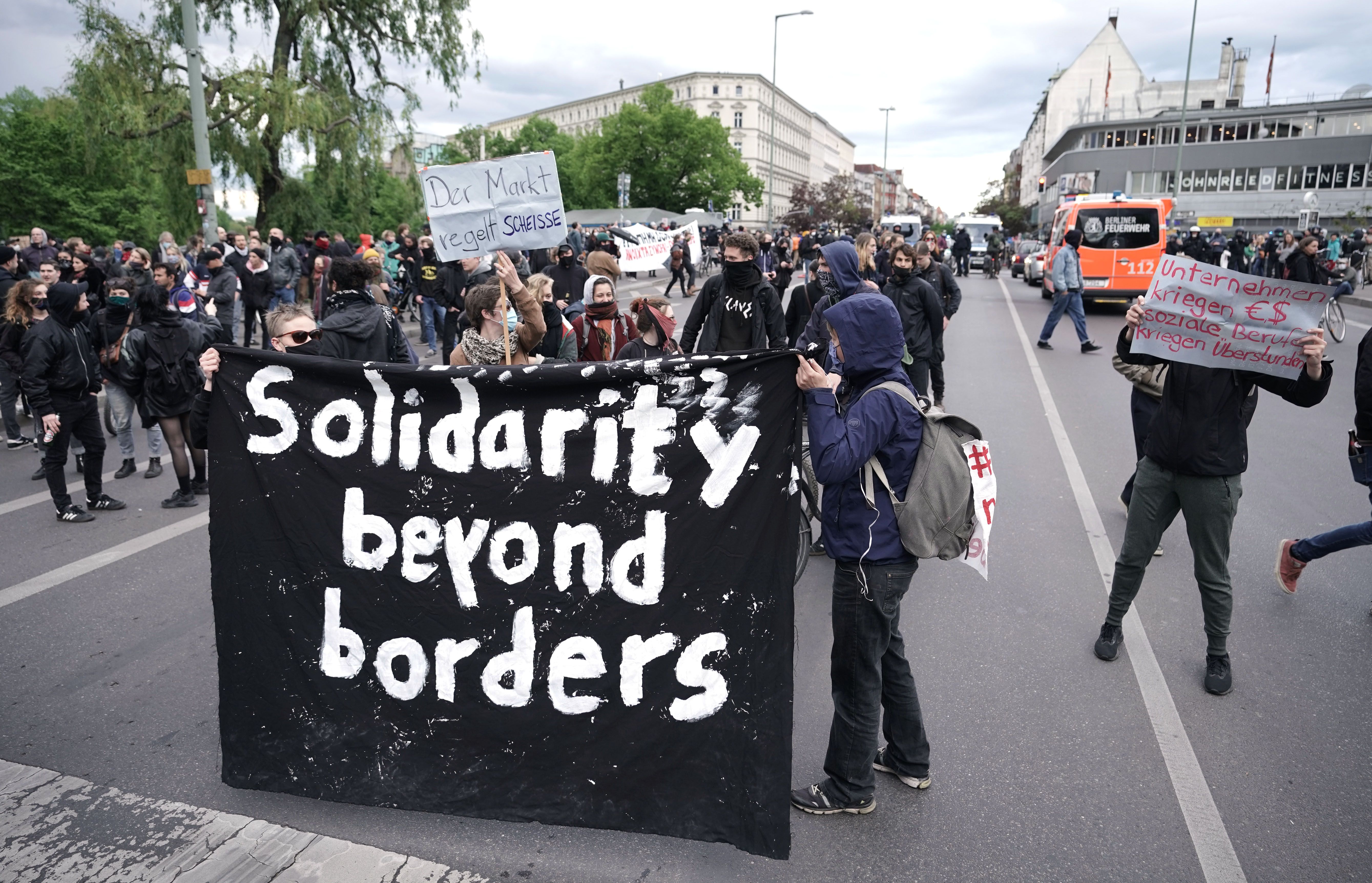 In t his image, a large banner sign reads "solidarity beyond borders"