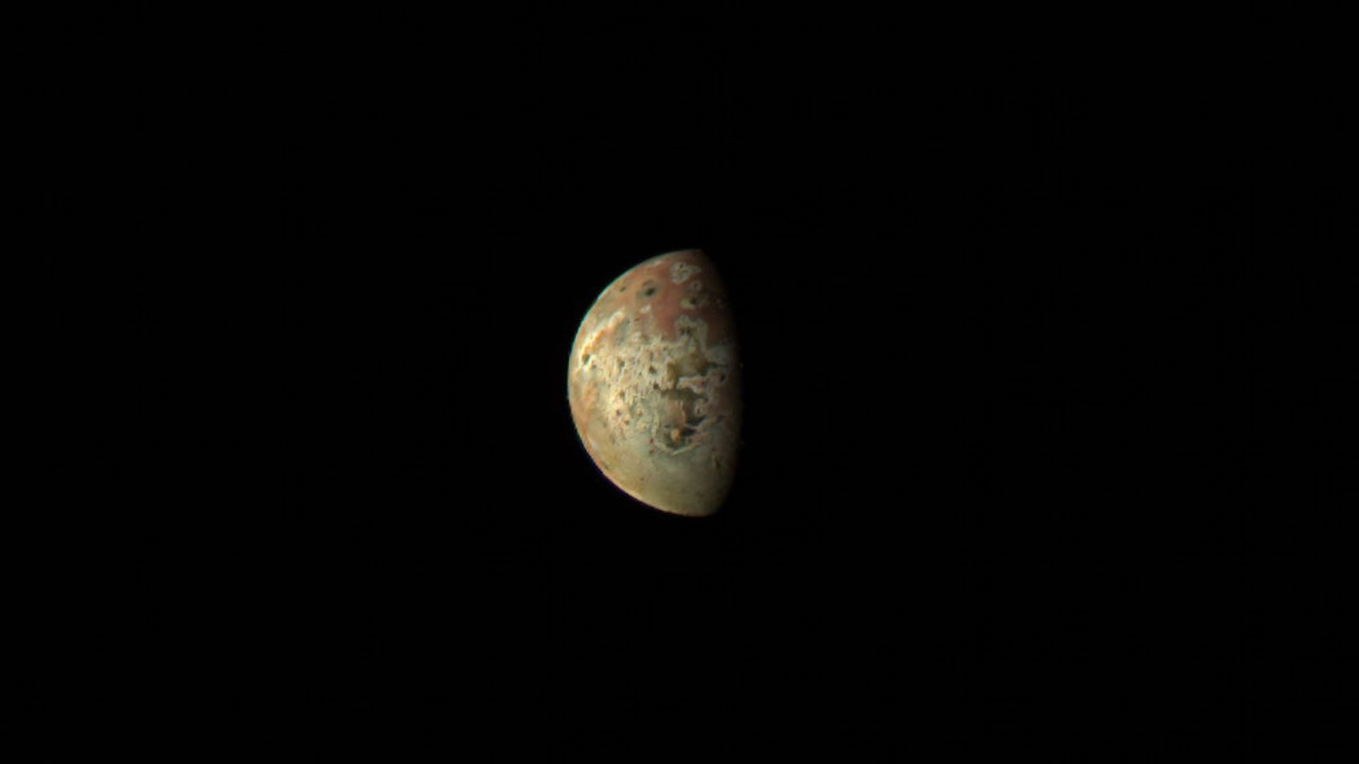 Jupiter's moon Io, shining in yellow and red on its day side
