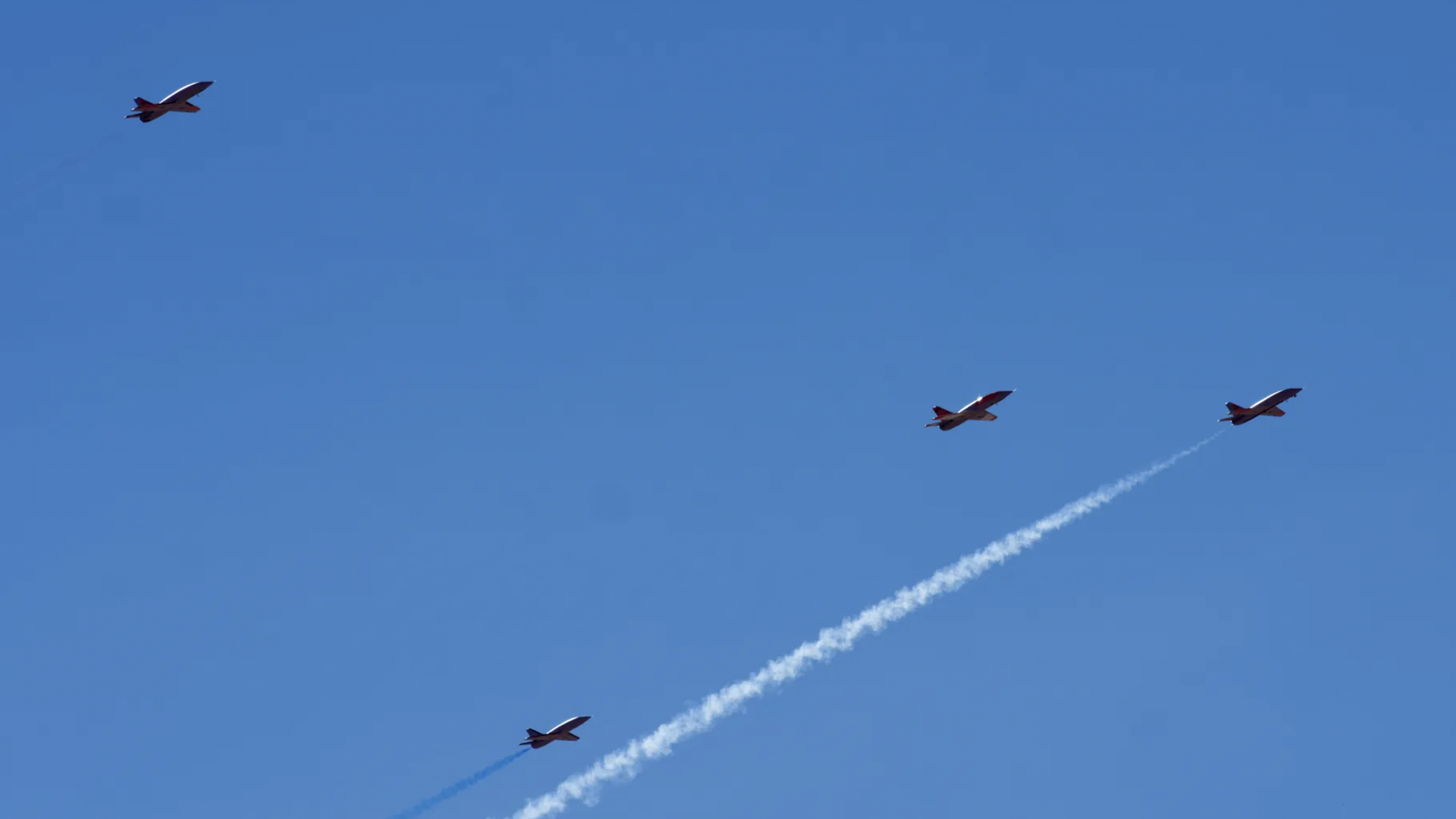 Four drones fly in a flight pattern. 