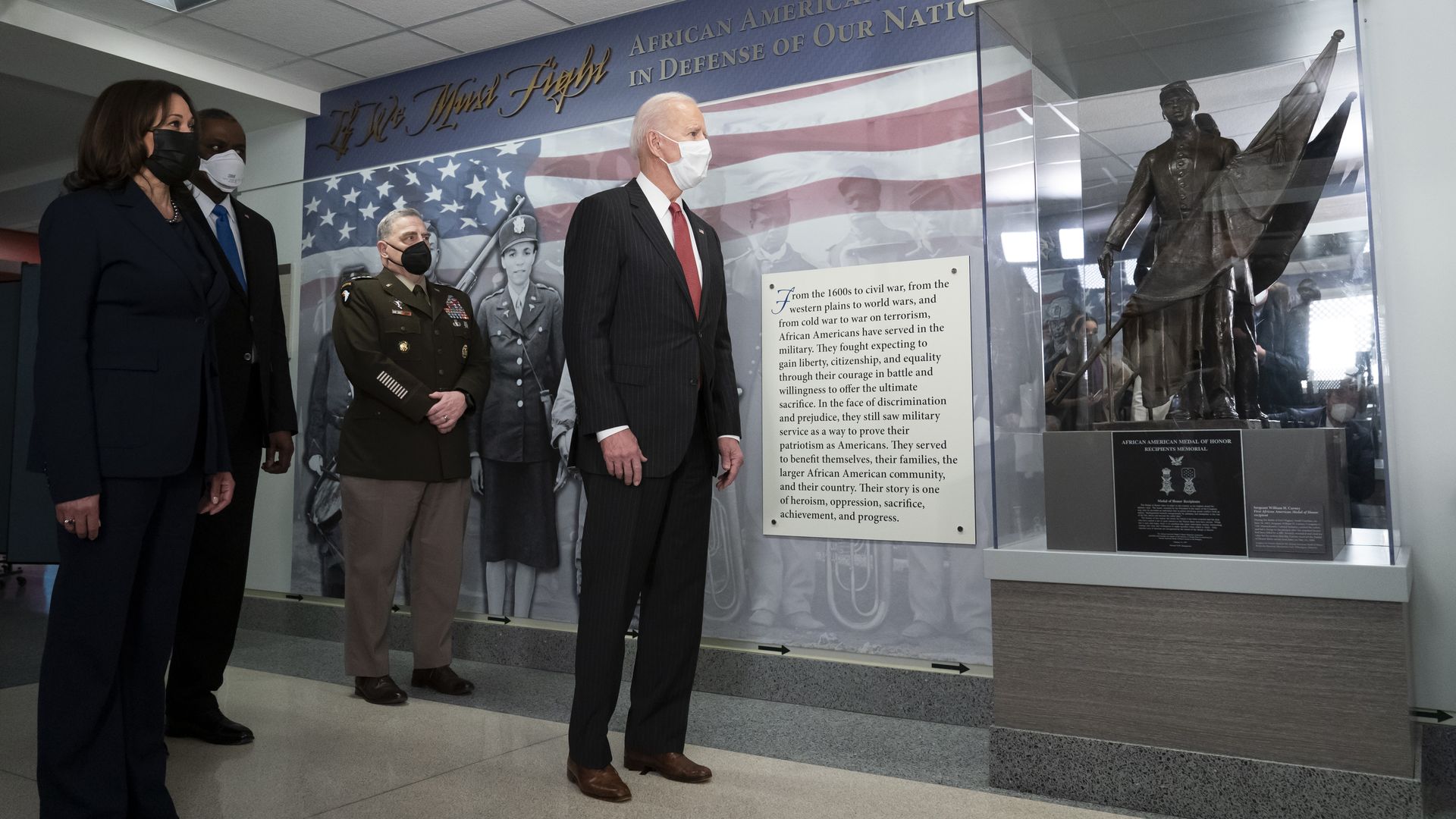 President Biden is seen at the Pentagon, looking at a display honoring African American service members.