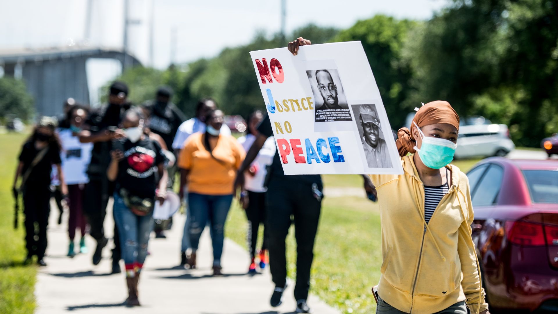 People return to their vehicles after gathering to honor the life of Ahmaud Arbery at Sidney Lanier Park on May 9, 2020 in Brunswick, Georgia.