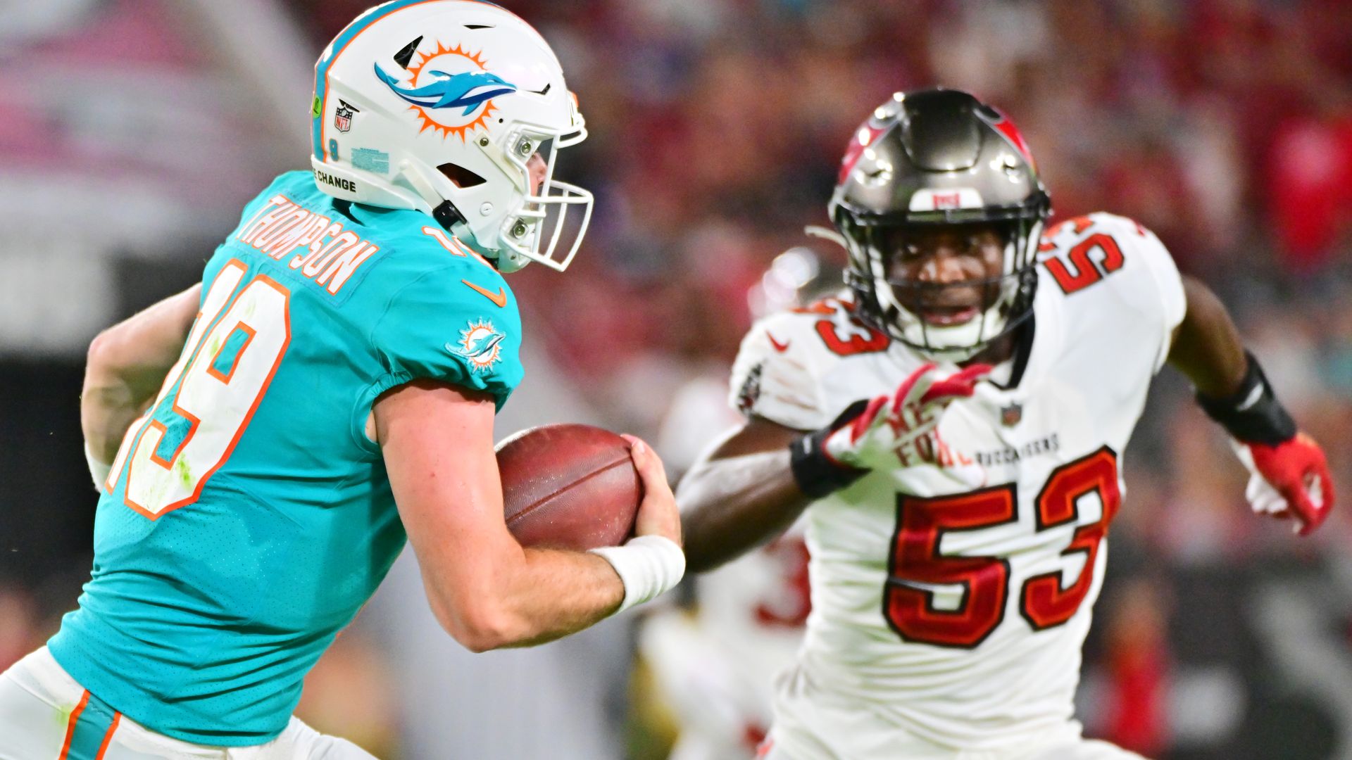 Skylar Thompson #19 of the Miami Dolphins runs the ball against Olakunle Fatukasi #53 of the Tampa Bay Buccaneers during a preseason NFL football game on August 13, 2022 in Tampa, Florida. 