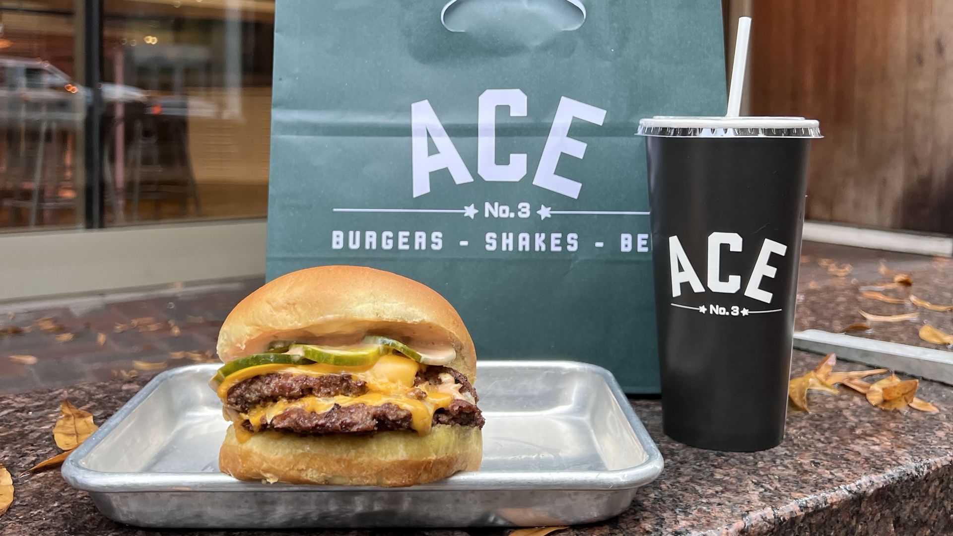 burger and soda cup with "ACE" written on it
