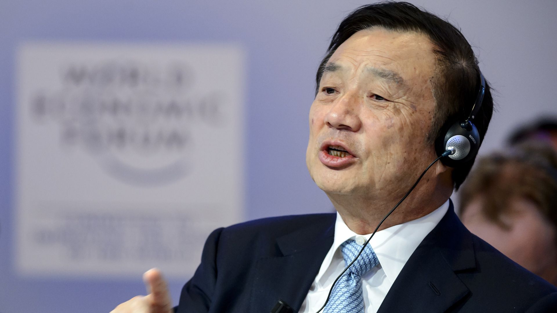 Huawei founder with translation headset on