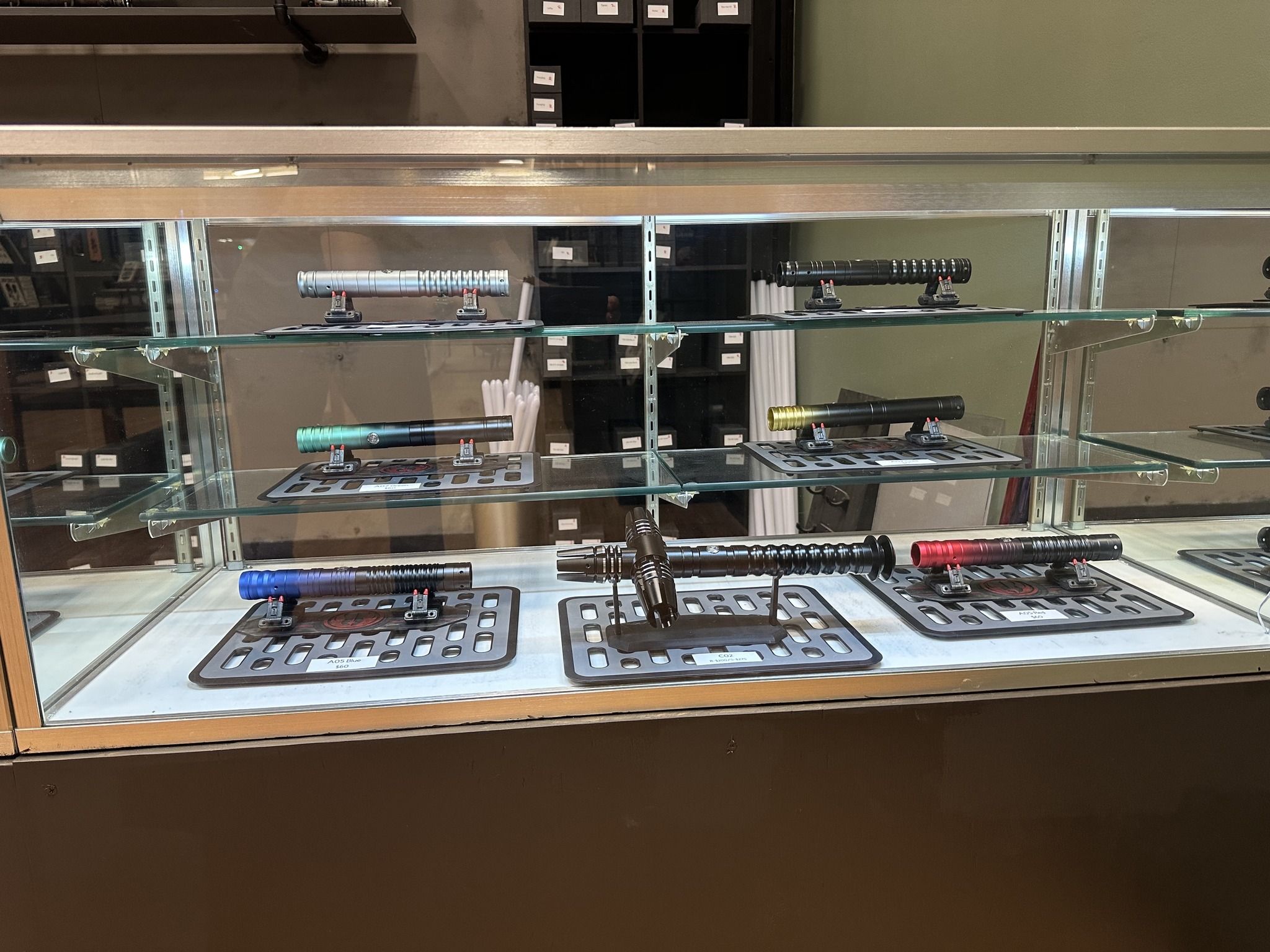 Custom light saber parts inside a glass case