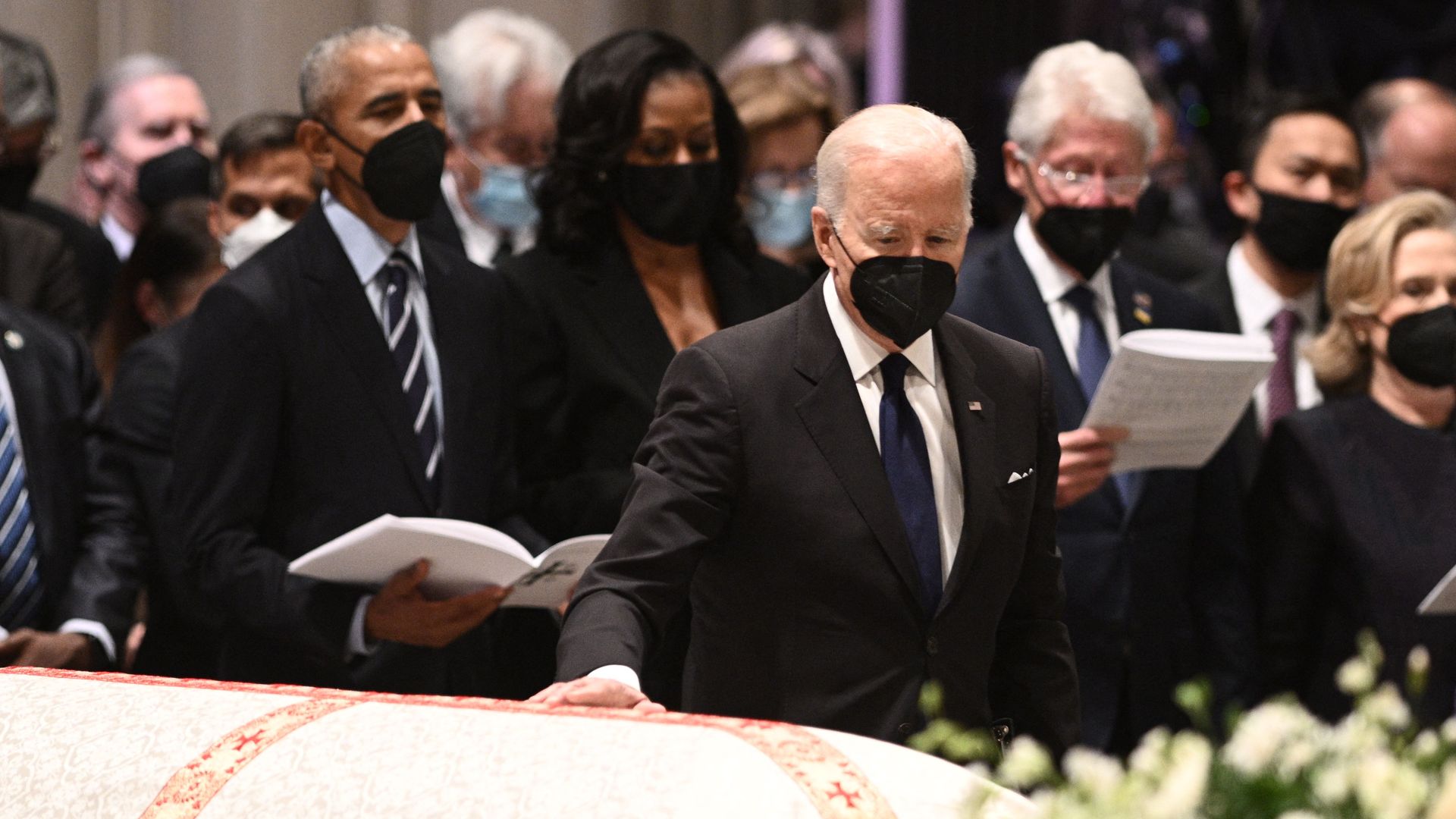 President Biden, flanked by former Presidents Obama and Clinton, touches the casket of the late Secretary of State Madeleine Albright.