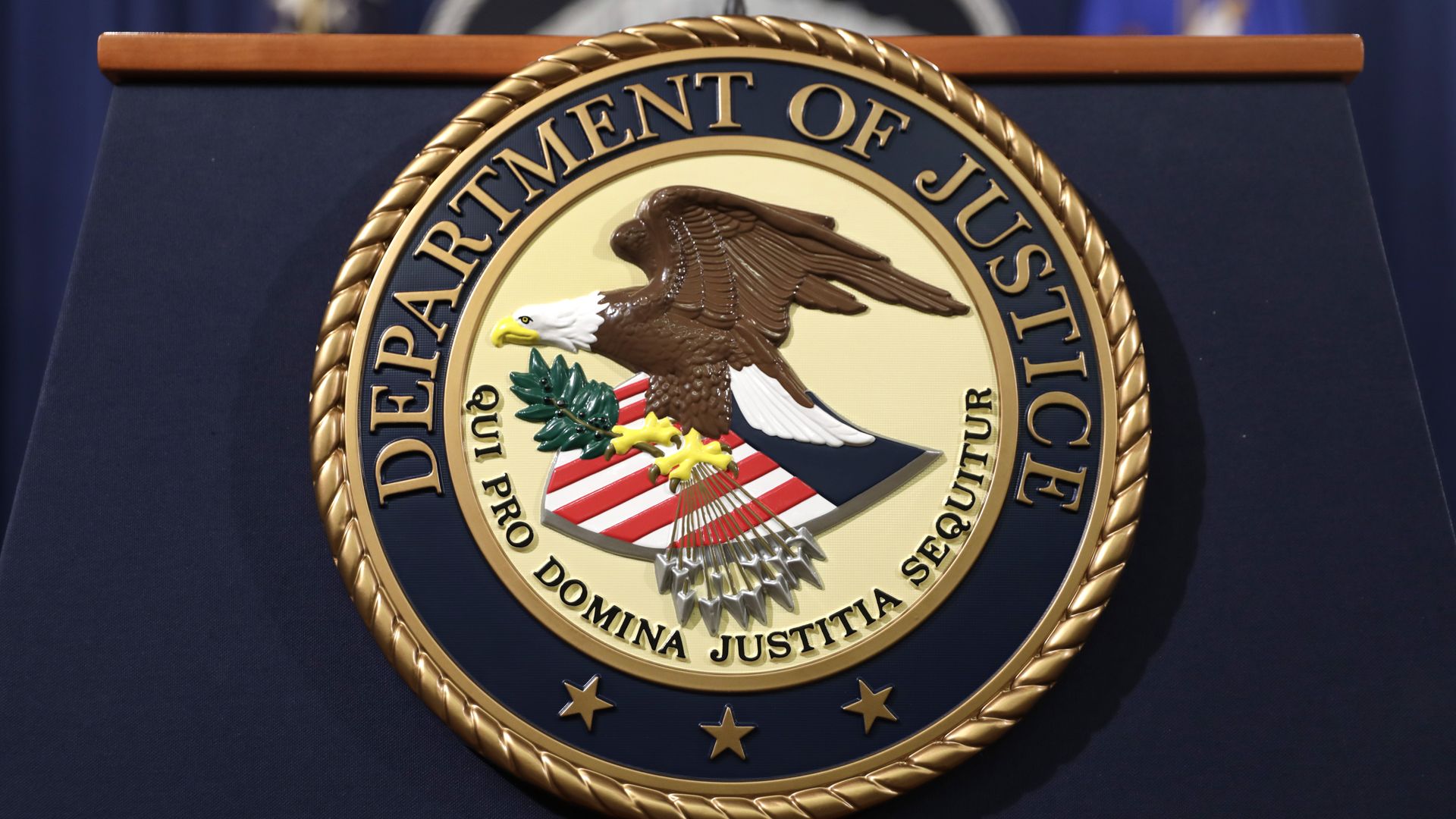 Photo of the DOJ seal with an eagle on it