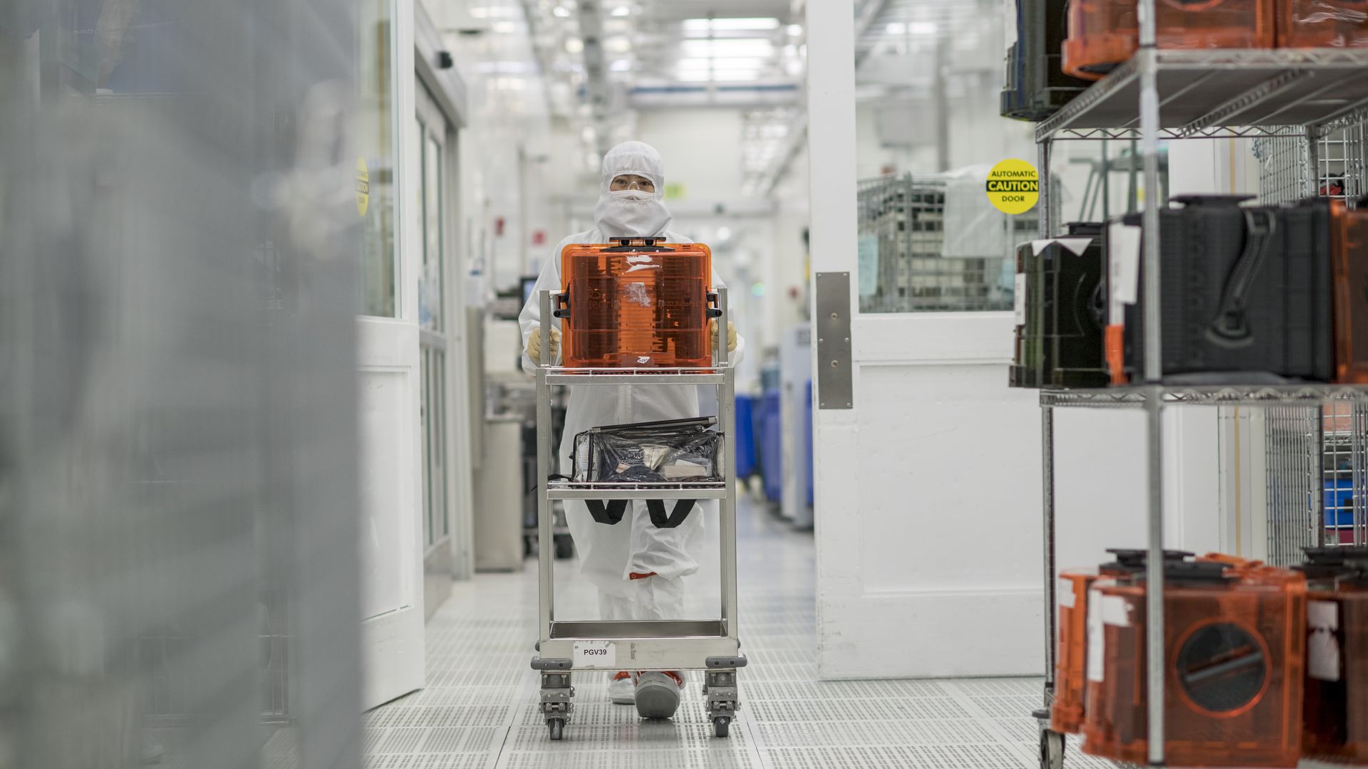 A technician pushes a cart of semiconductor wafers at the Applied Materials Inc. facility in Santa Clara, California, U.S., on Tuesday, Oct. 21, 2016. 