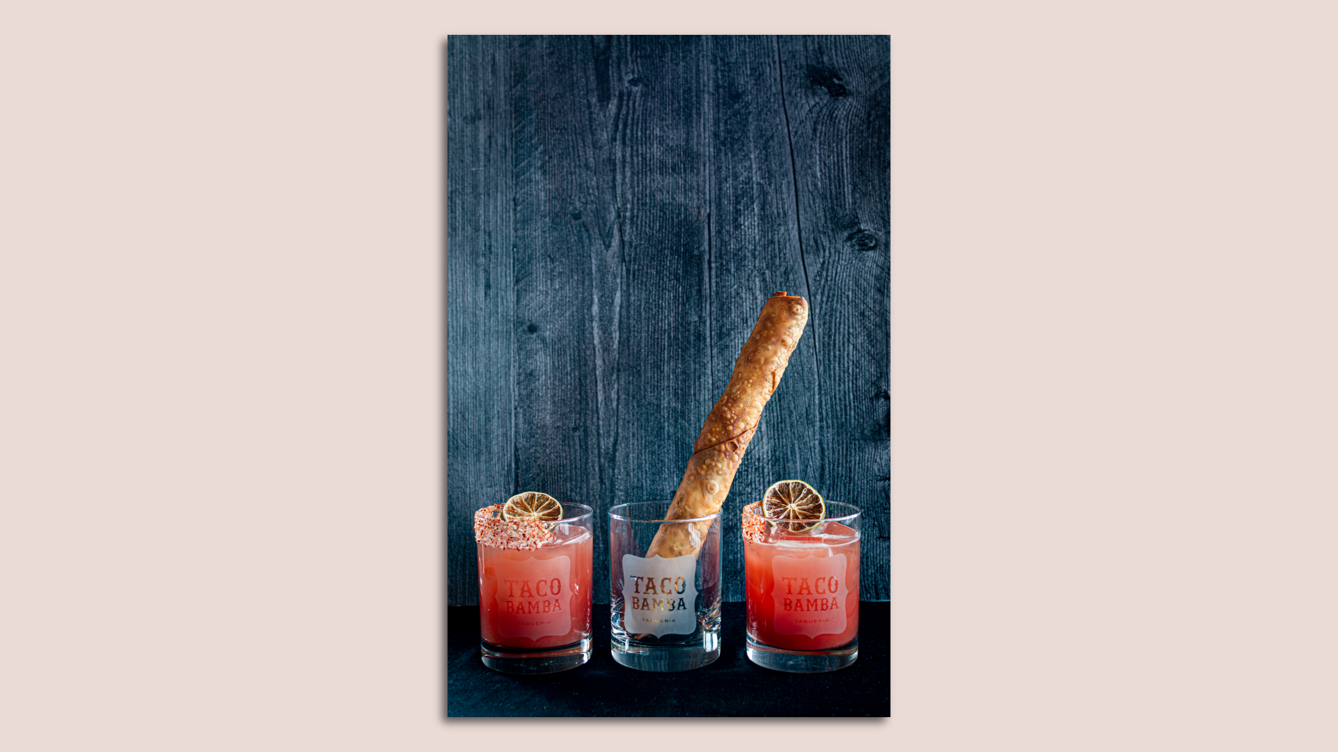 Two blood orange margaritas with a Mexican egg roll in between 