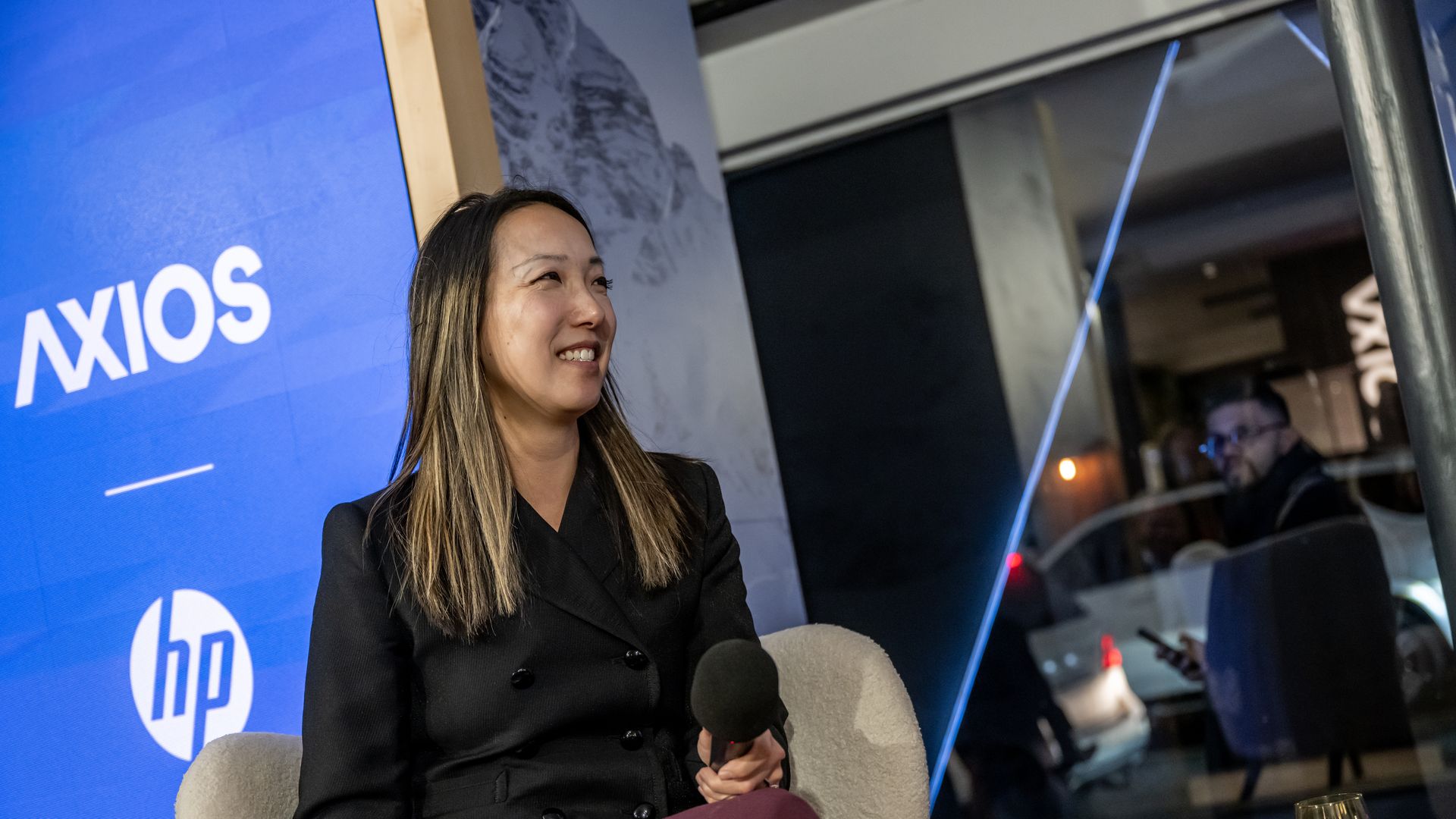 Salesforce’s Clara Shih sitting and smiling on the Axios stage. 