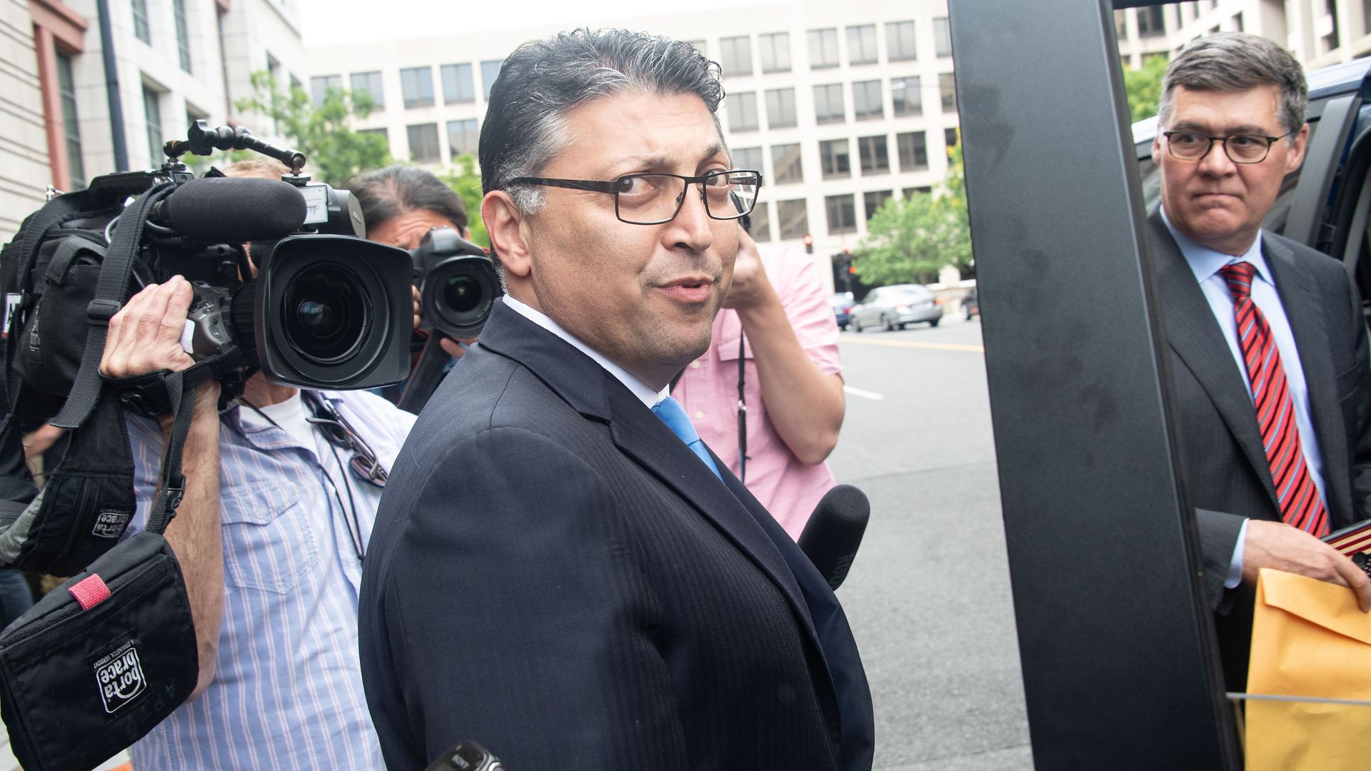 Makan Delrahim surrounded by cameras