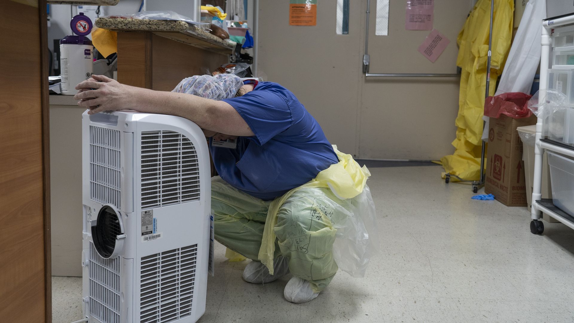 A medical staff member rests in front of a fan in the Covid-19 intensive care unit at the United Memorial Medical Center on June 30, 2020 in Houston, Texas.
