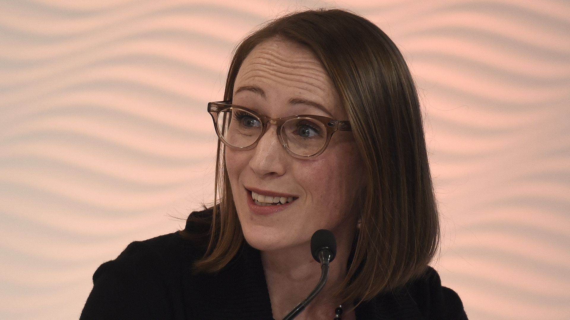 Photo of Hardiman speaking into a microphone on stage