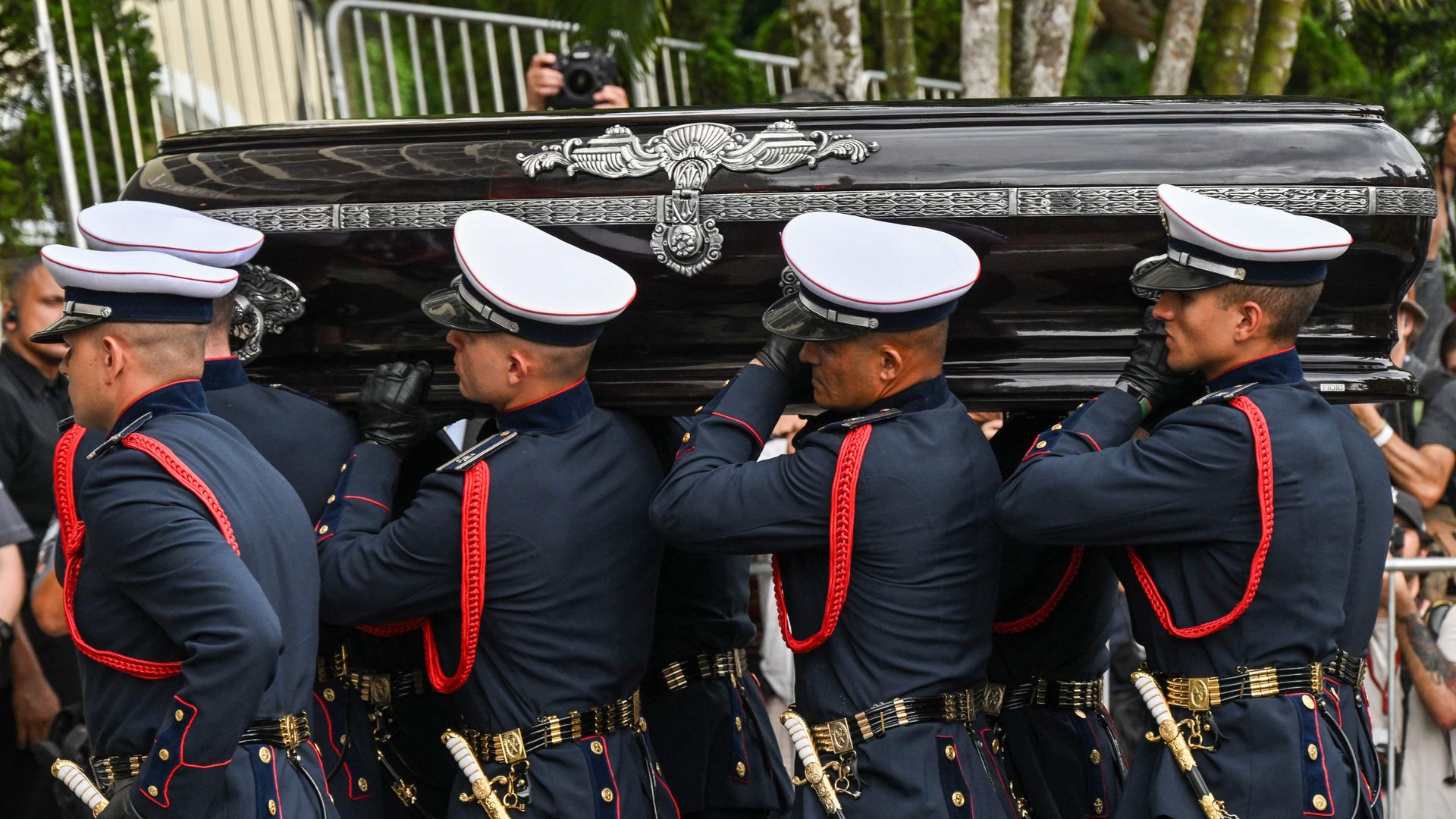 The coffin of the late soccer legend Pelé arrives at a cemetery in Santos, Brazil.
