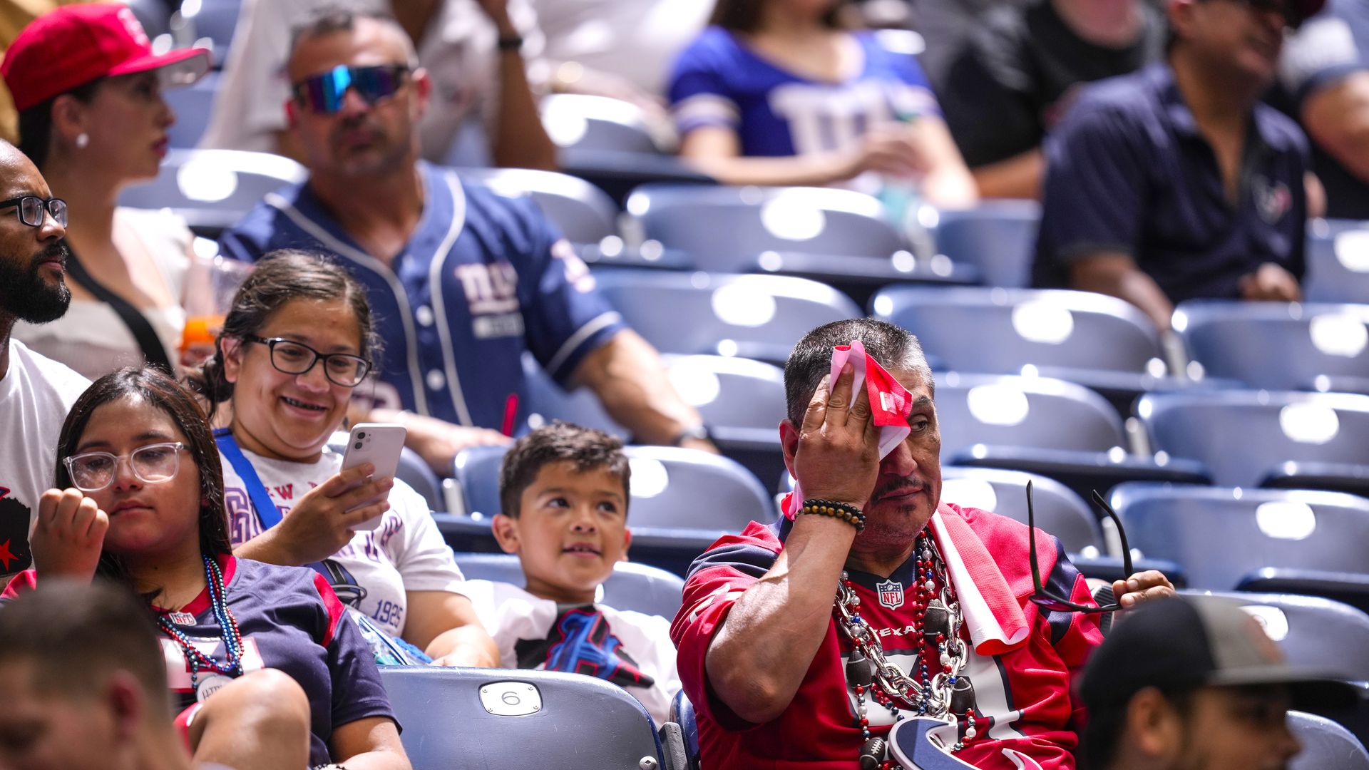 Football fan mops sweat during game in Houston
