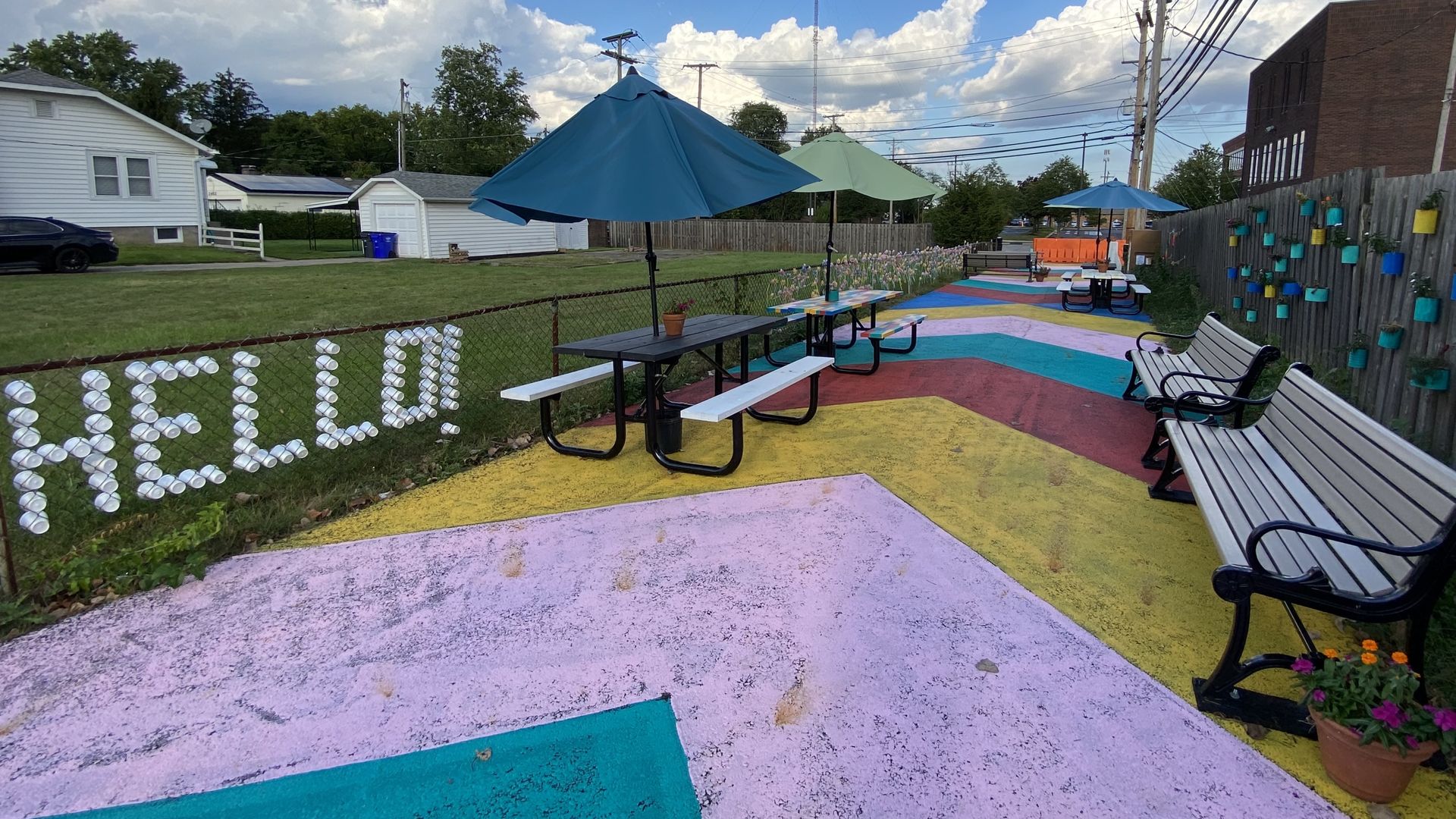 Popup park in Upper Arlington, with benches and picnic tables and a painted street 