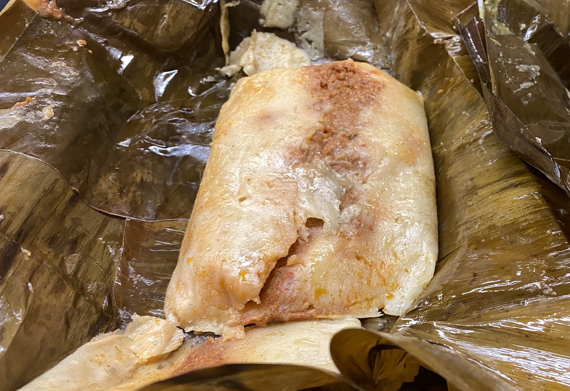 Tamale on top of banana leaf