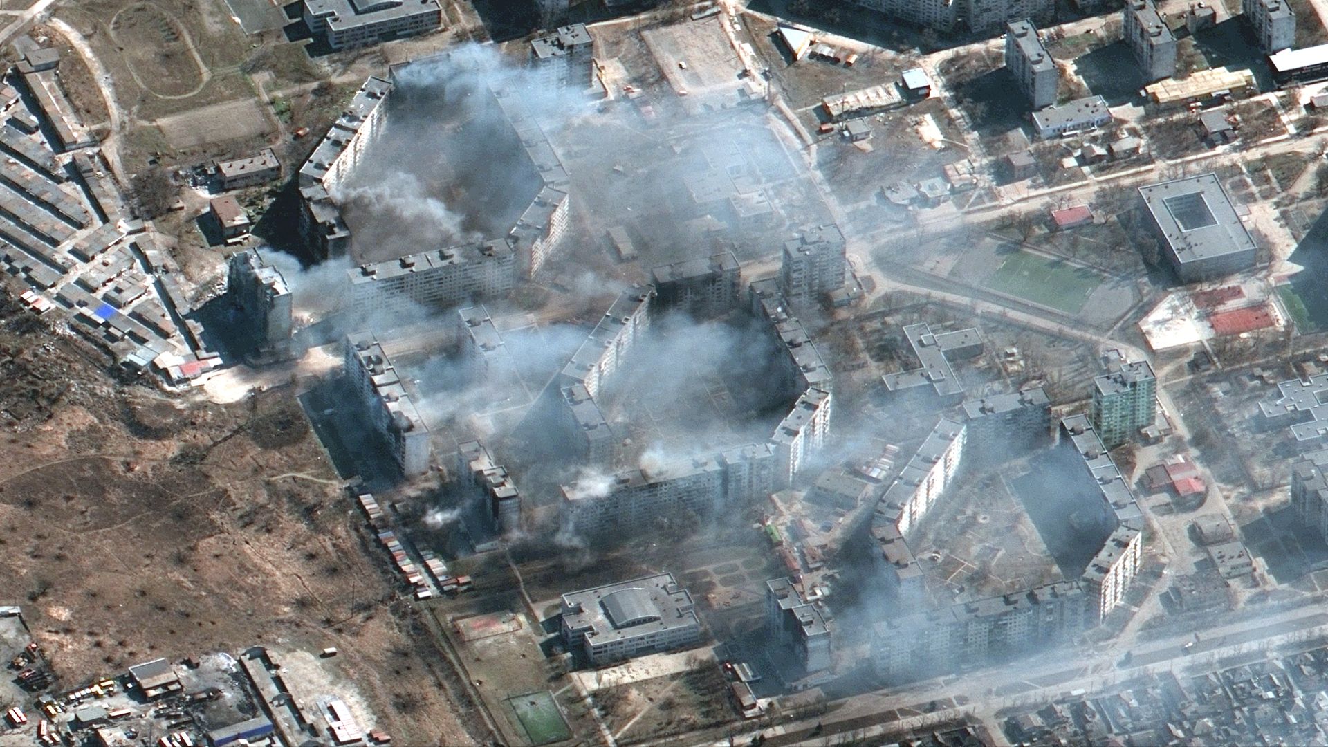 Burning apartment buildings likely shelled by artillery, burning buildings in Mariupol