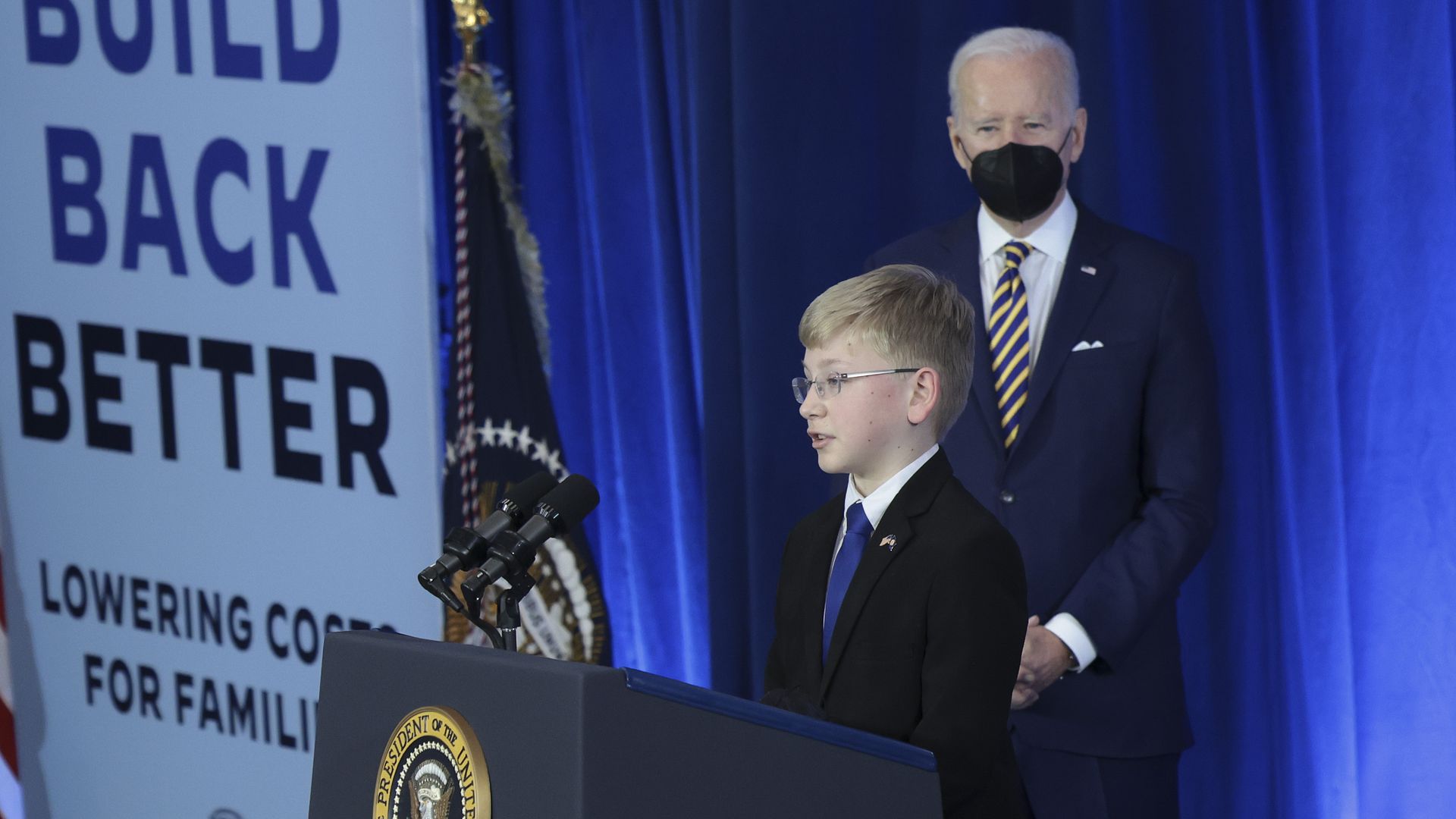 President Biden is seen watching as a 12-year-old introduces him before an event in Virginia.