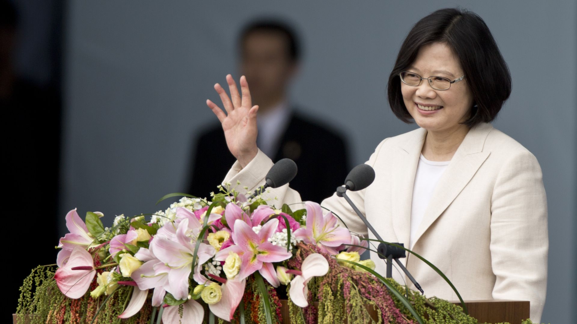 Taiwanese president Tsai Ing-wen waving from behind a lectern