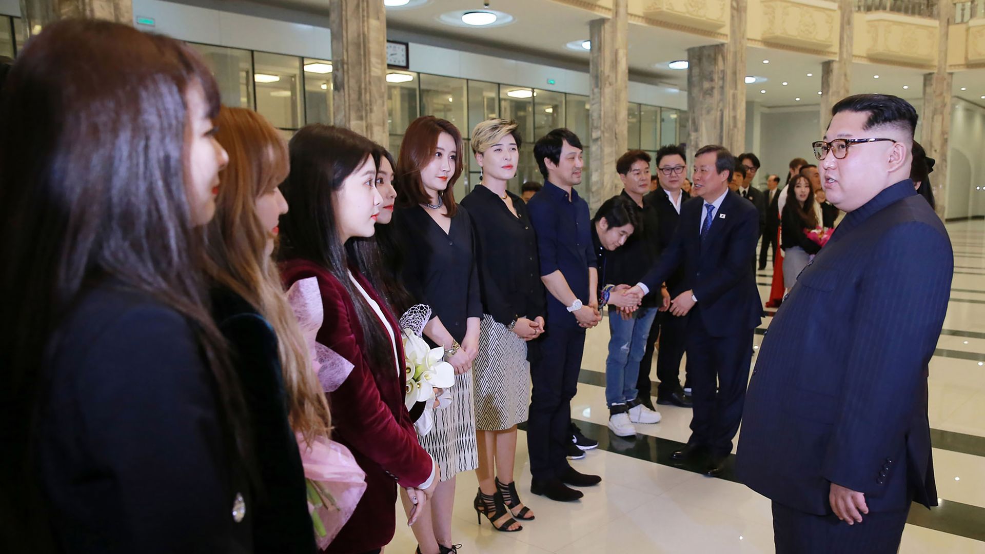 Kim Jong-un (right) speaks with South Korean performers (left) in Pyongyang.
