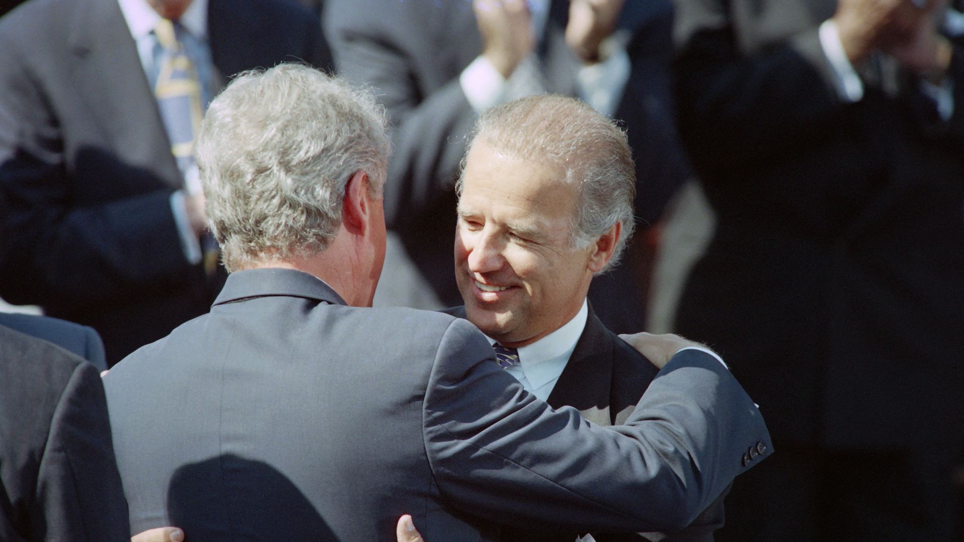 US President Bill Clinton (L) hugs Senator Joseph Biden, D-Del., on September 13, 1994 during a signing ceremony for the crime bill on the South Lawn of the White House. President Clinton said the crime bill would "roll back this awfull tide of violence" in the US. (Photo by Paul J. RICHARDS / AFP) 