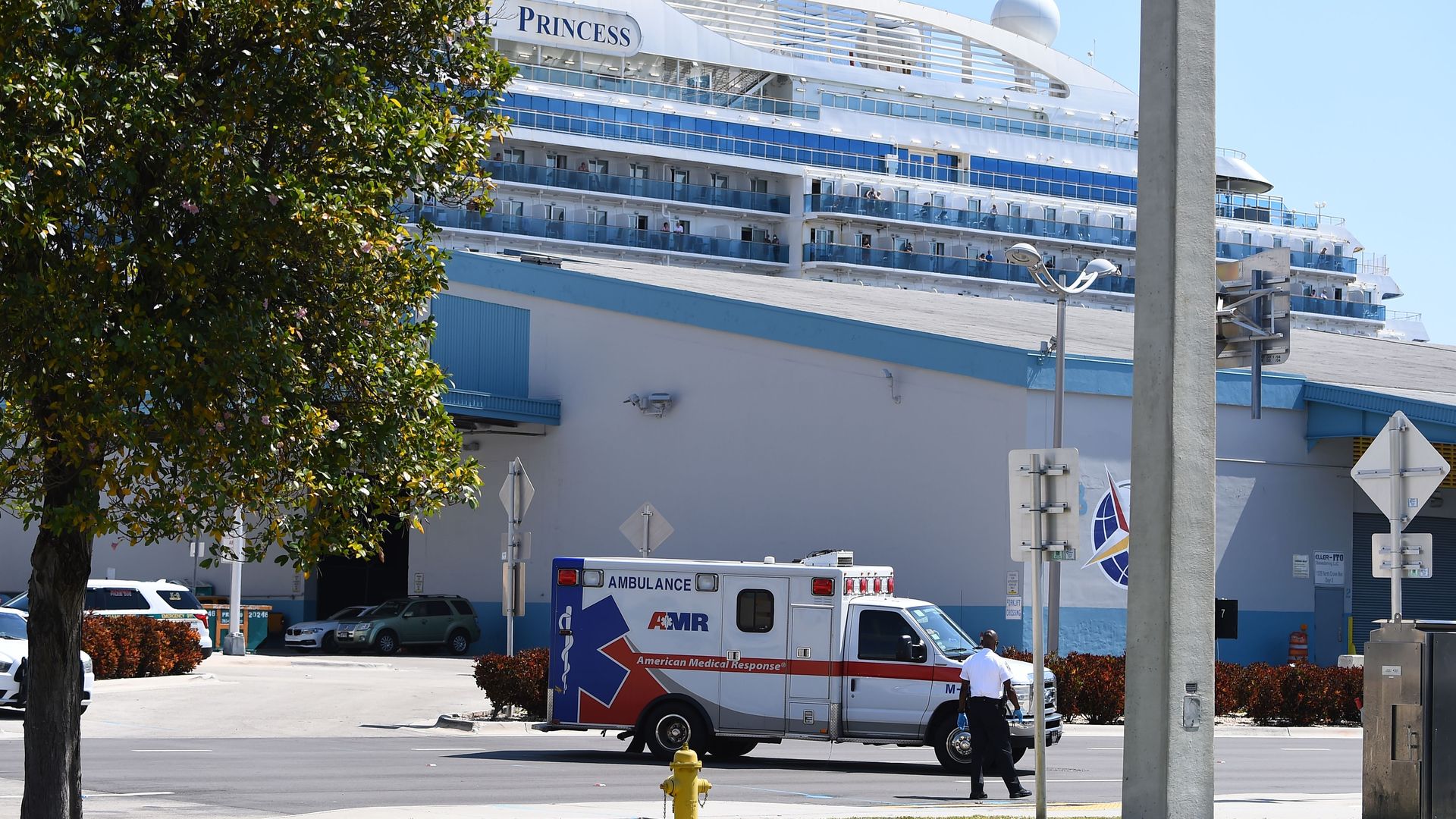 An ambulance takes a patient from the cruise ship Coral Princess to the hospital as the ship is docked at the Port of Miami, Florida
