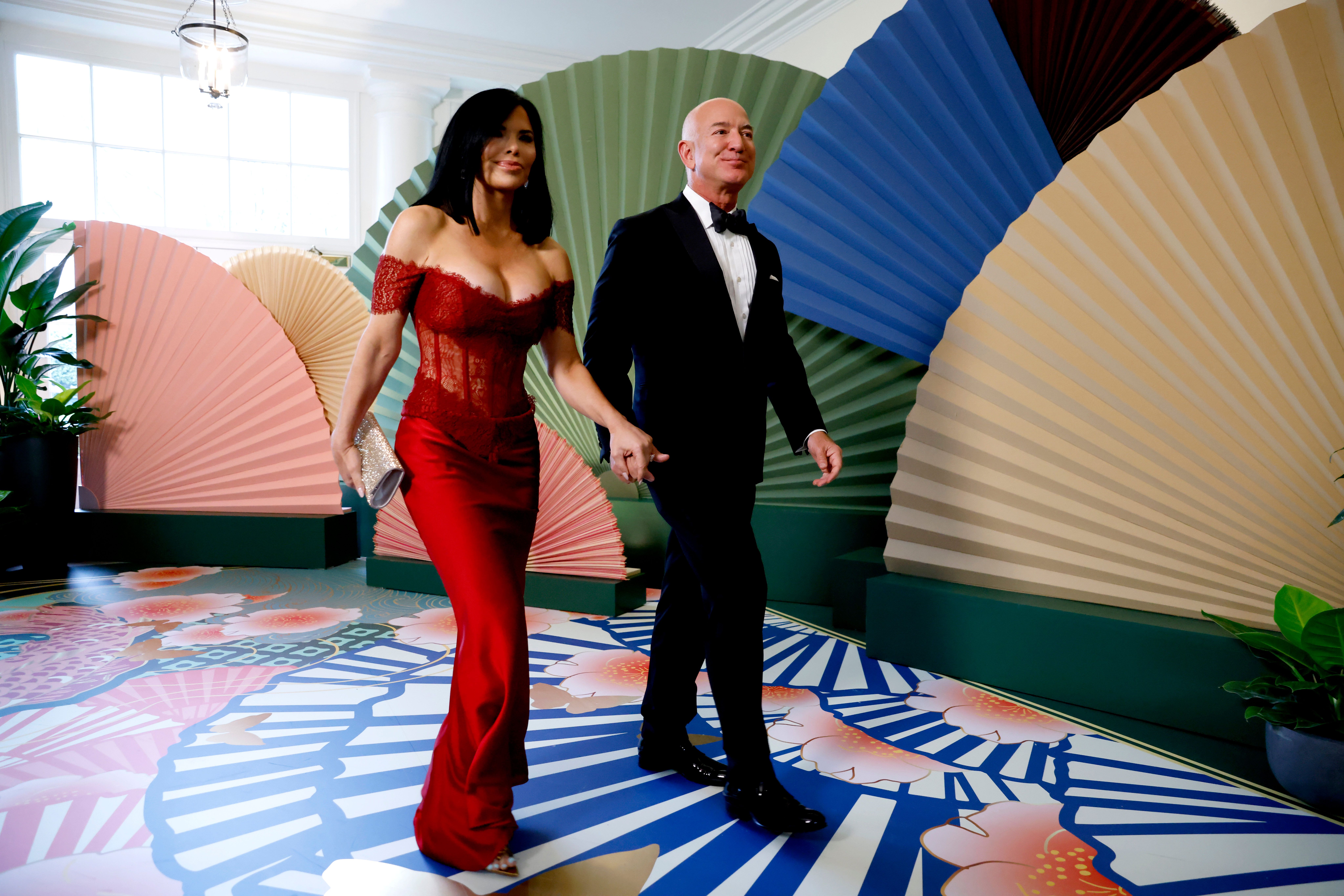 Jeff Bezos, founder of Amazon.com Inc., right, and Lauren Sanchez arrive to attend a state dinner in honor of Japanese Prime Minister Fumio Kishida hosted by US President Joe Biden and First Lady Jill Biden at the White House in Washington, DC, US, on Wednesday, April 10, 2024. 