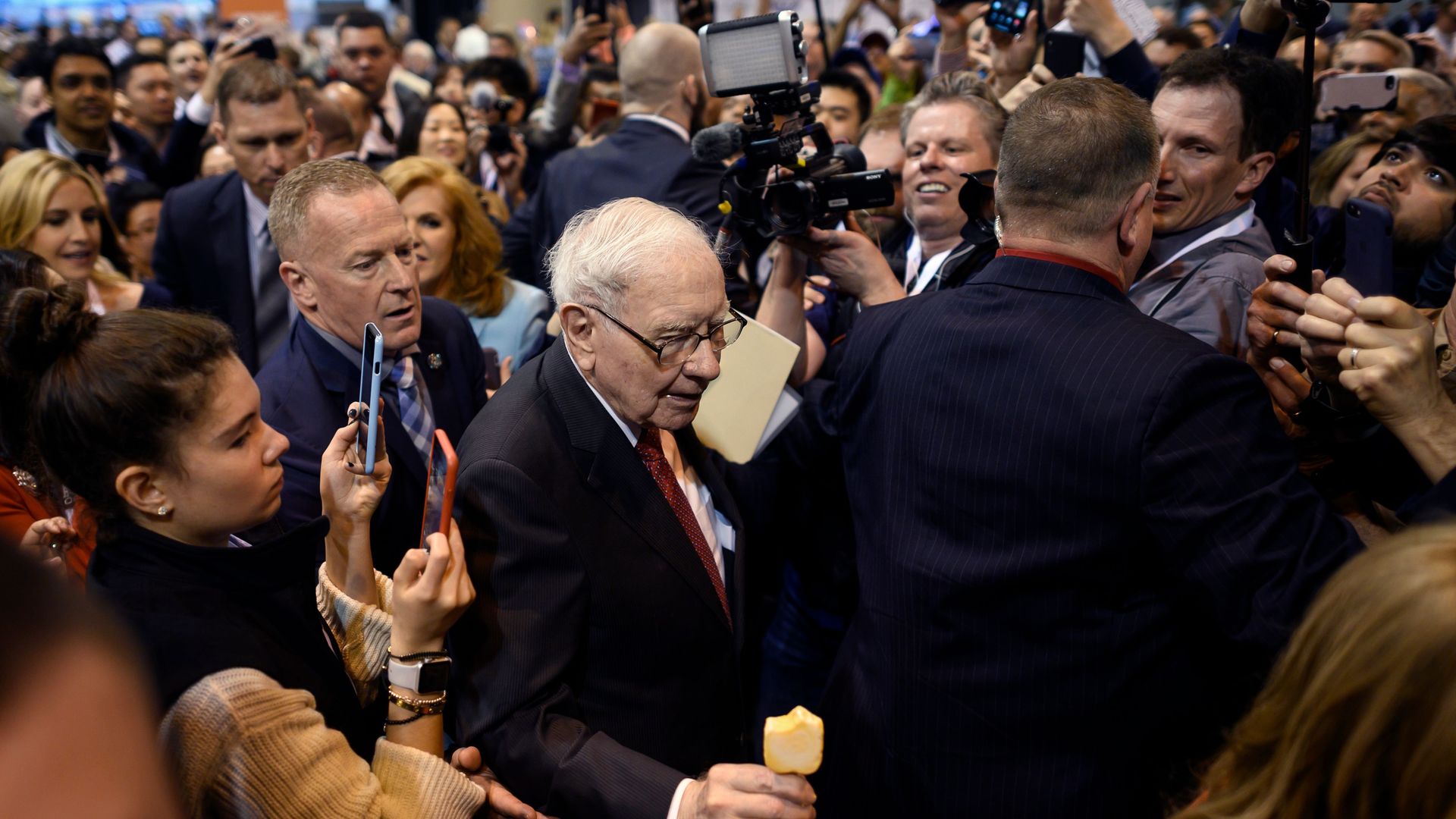 A photo of Warren Buffett surrounded by fans