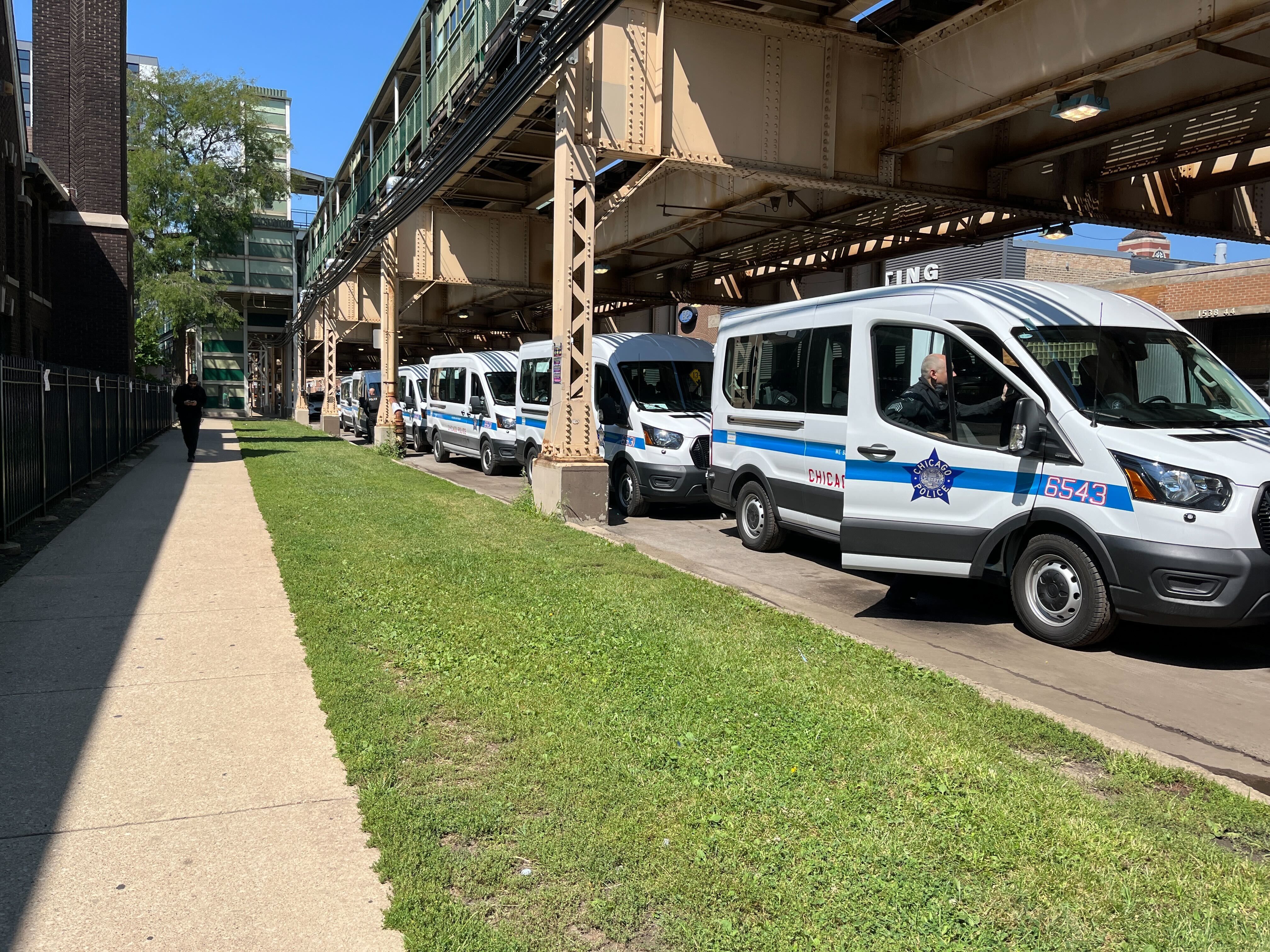 police busses lined up underneath a bridge