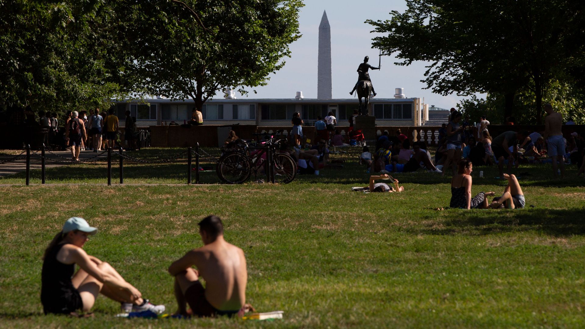 People gather to sit and lounge on the Meridian Hill Park lawn during warm weather