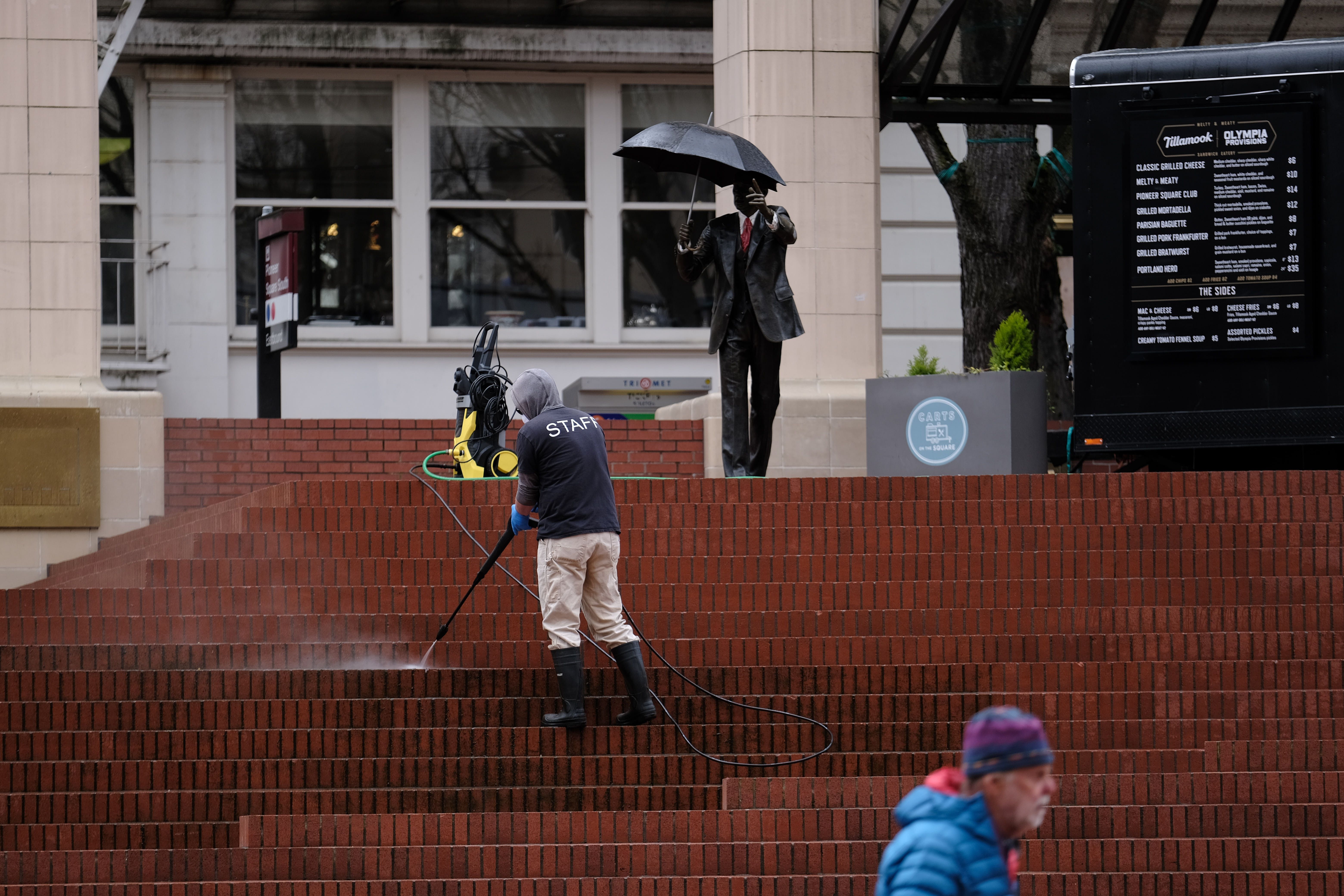 A worker cleans the steps at Pioneer Square in Portland, Ore., on April 3