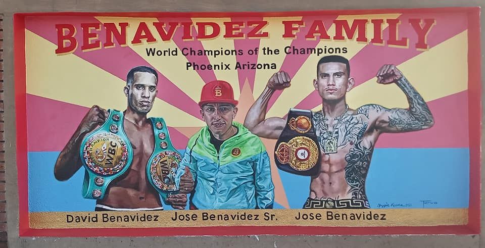 A mural with images of two boxes holding championship belts and a third man between them, with the words "Benevidez Family" over them. 