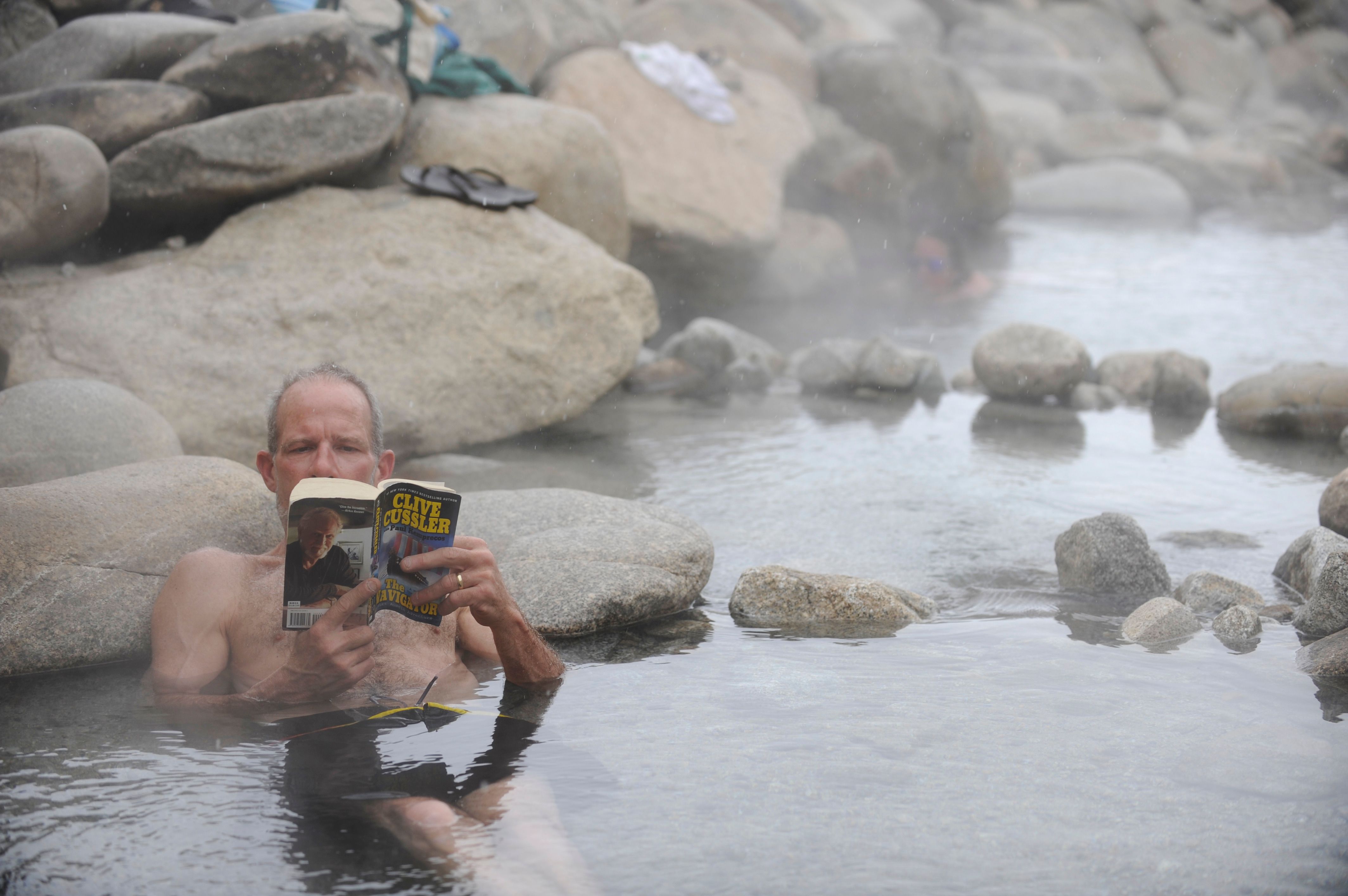 A man reading a book at Mount Princeton Hot Springs Resort