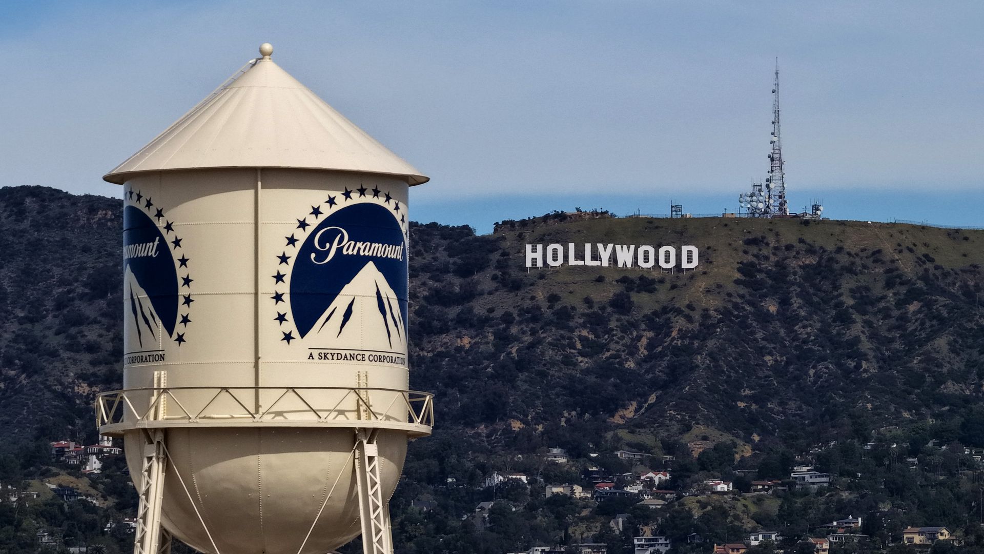 The Paramount water tower stands in the foreground with the Hollywood sign in the background.