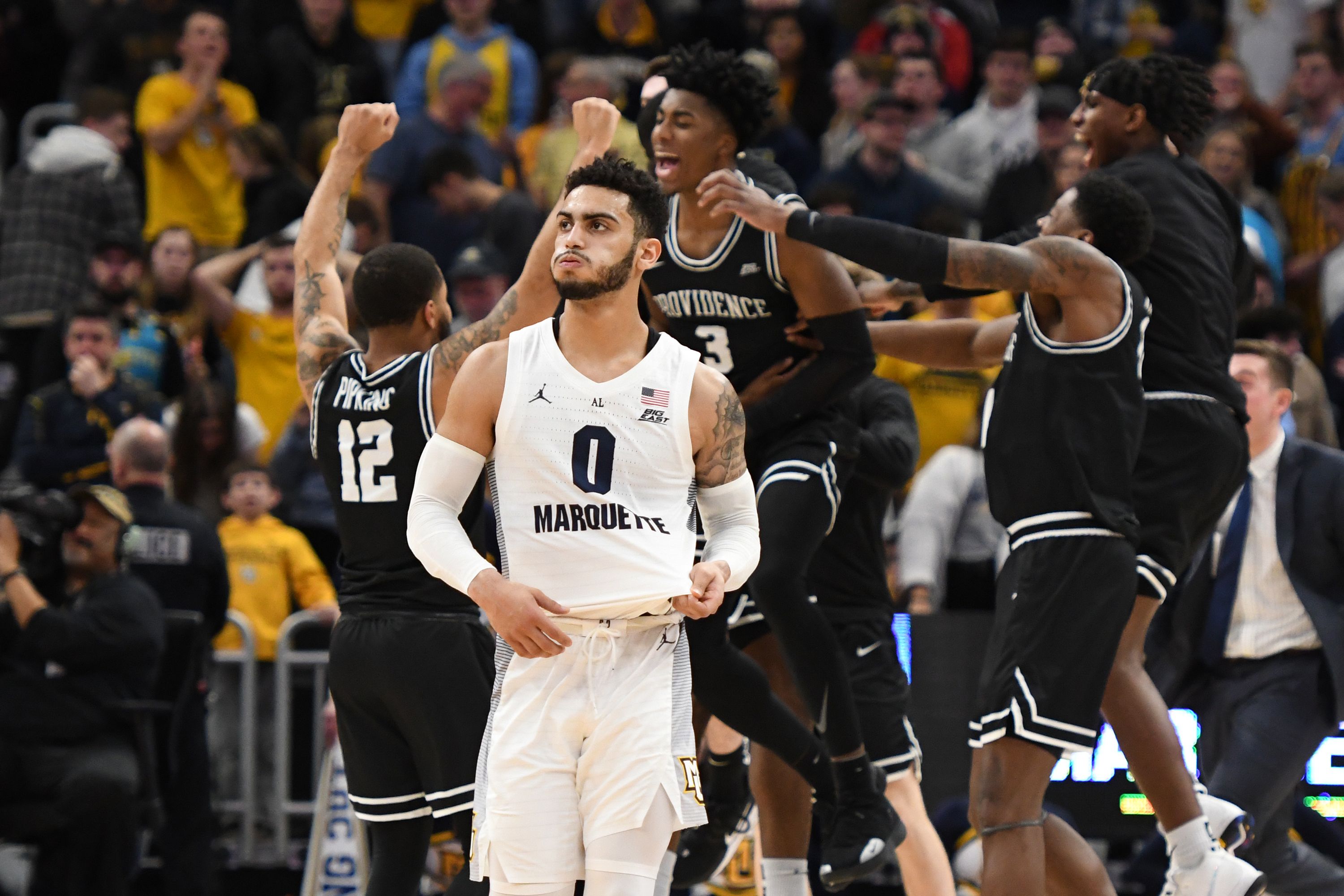 Providence players celebrating behind Markus Howard