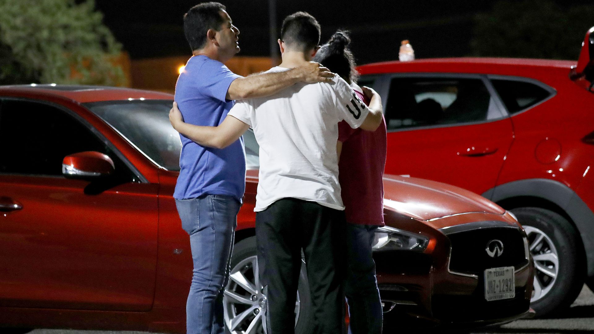 Members of the Arenas family, who are from El Paso and came to pray for victims, embrace outside Walmart near the scene of a mass shooting which left at least 20 people dead