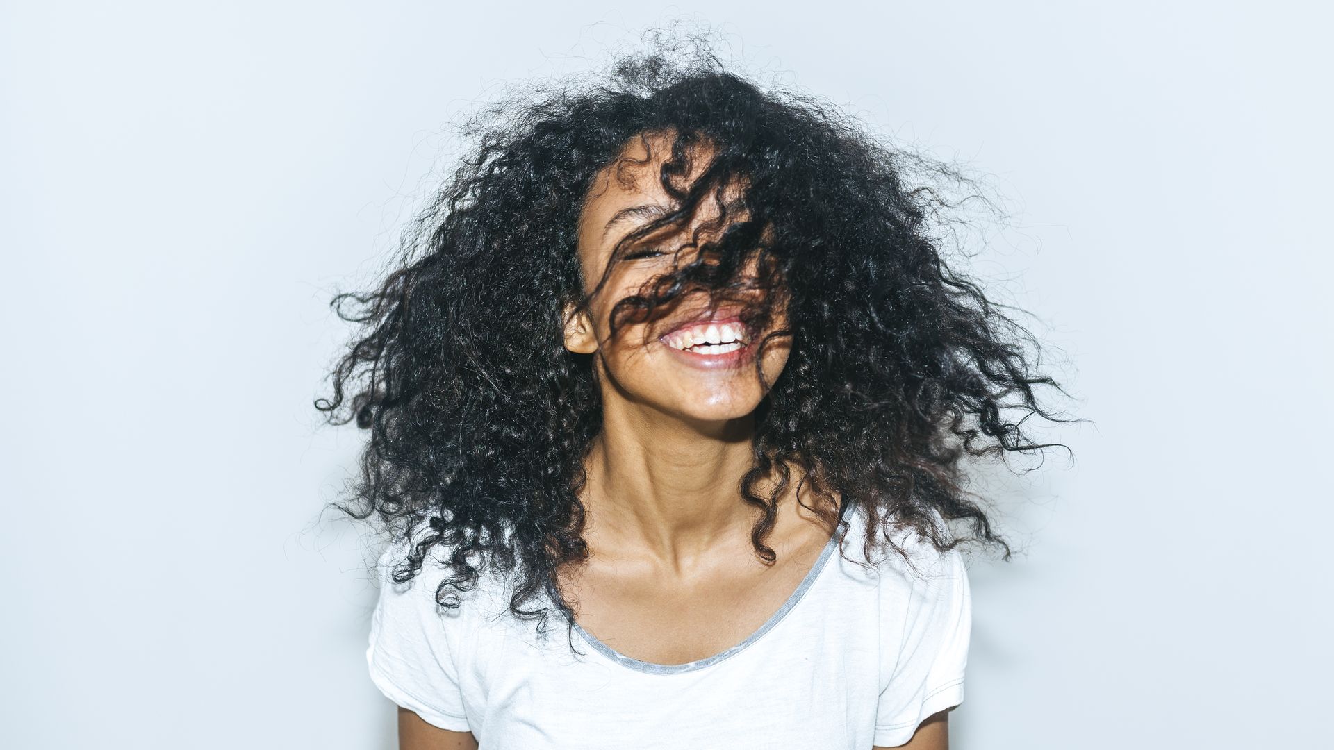 A woman smiling with her hair