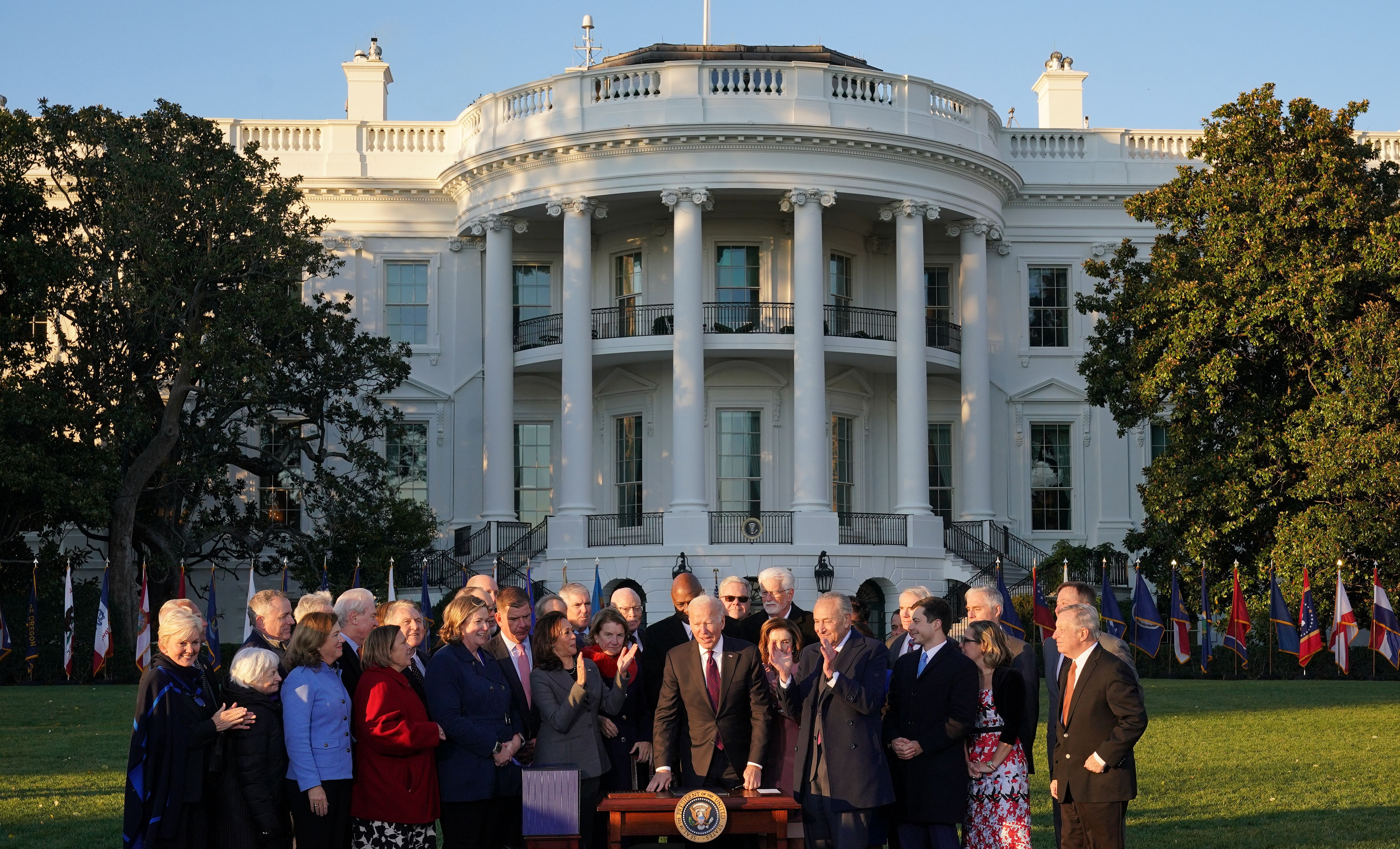 President Biden is seen with the White House behind him during the ceremony to sign the bipartisan infrastructure bill.