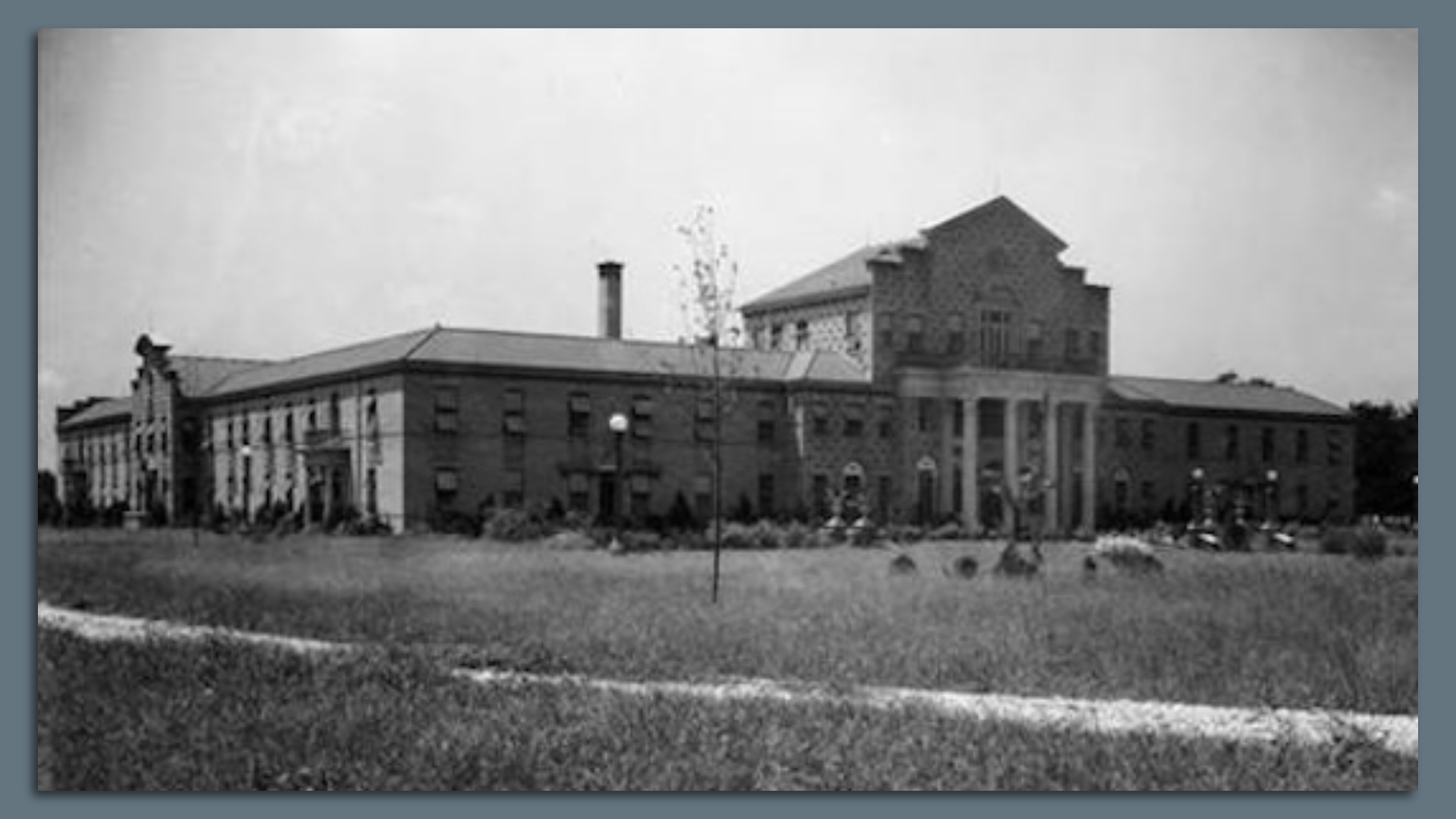 A black and white photo of a Classical-style building.