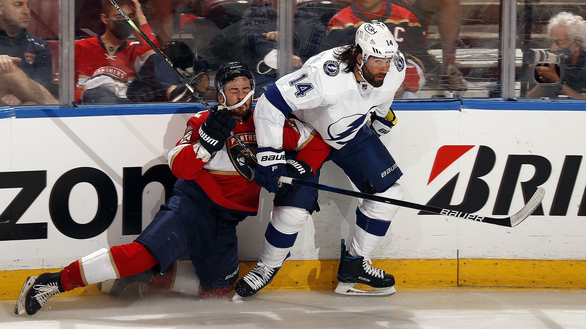 Pat Maroon #14 of the Tampa Bay Lightning tangles with MacKenzie Weegar #52 of the Florida Panthers