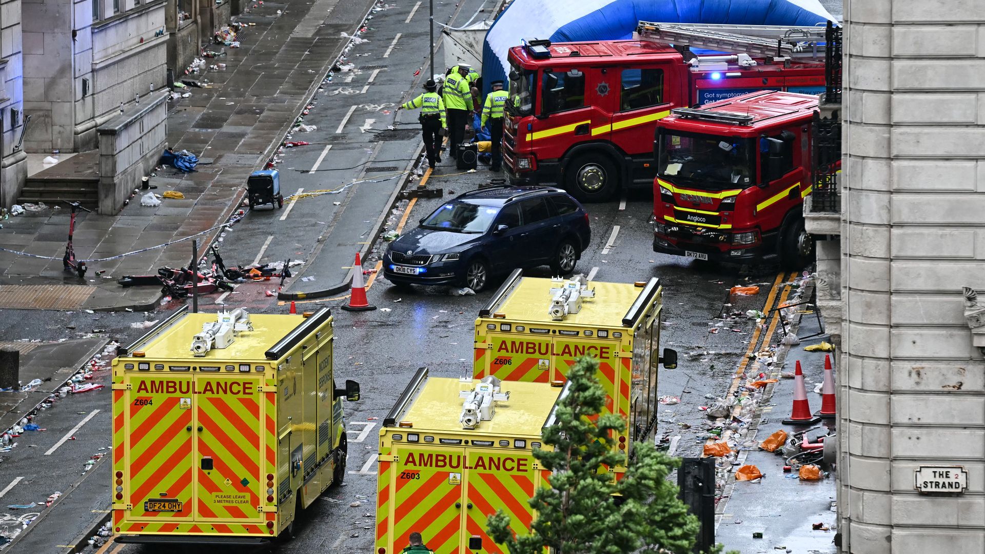  Police officers cover with an inflatable tent, behind a firefighter vehicle, the tents delimiting the scene of an incident in Water Street, on the sidelines of an open-top bus victory parade for Liverpool's Premier League title win, in Liverpool, north-west England on May 26, 2025. 