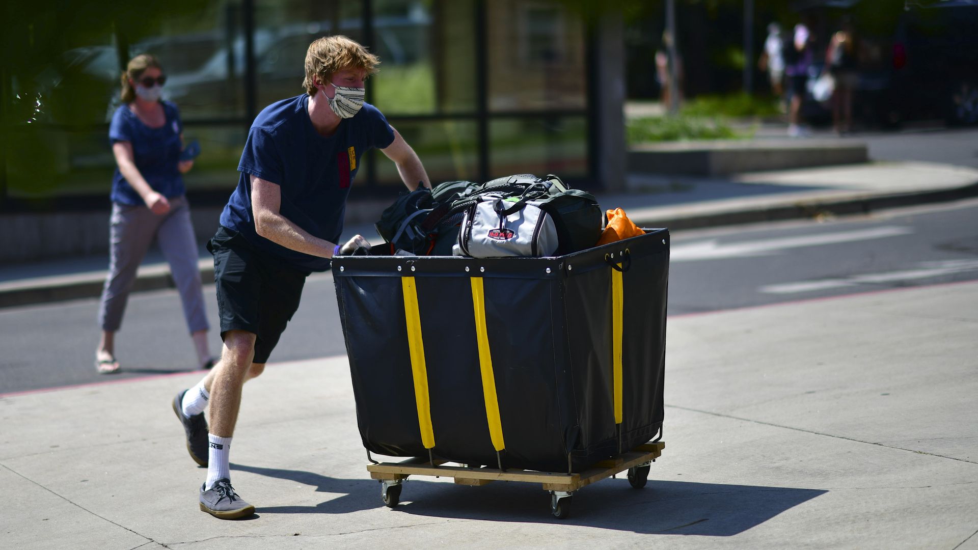 student moves into a dorm on college campus