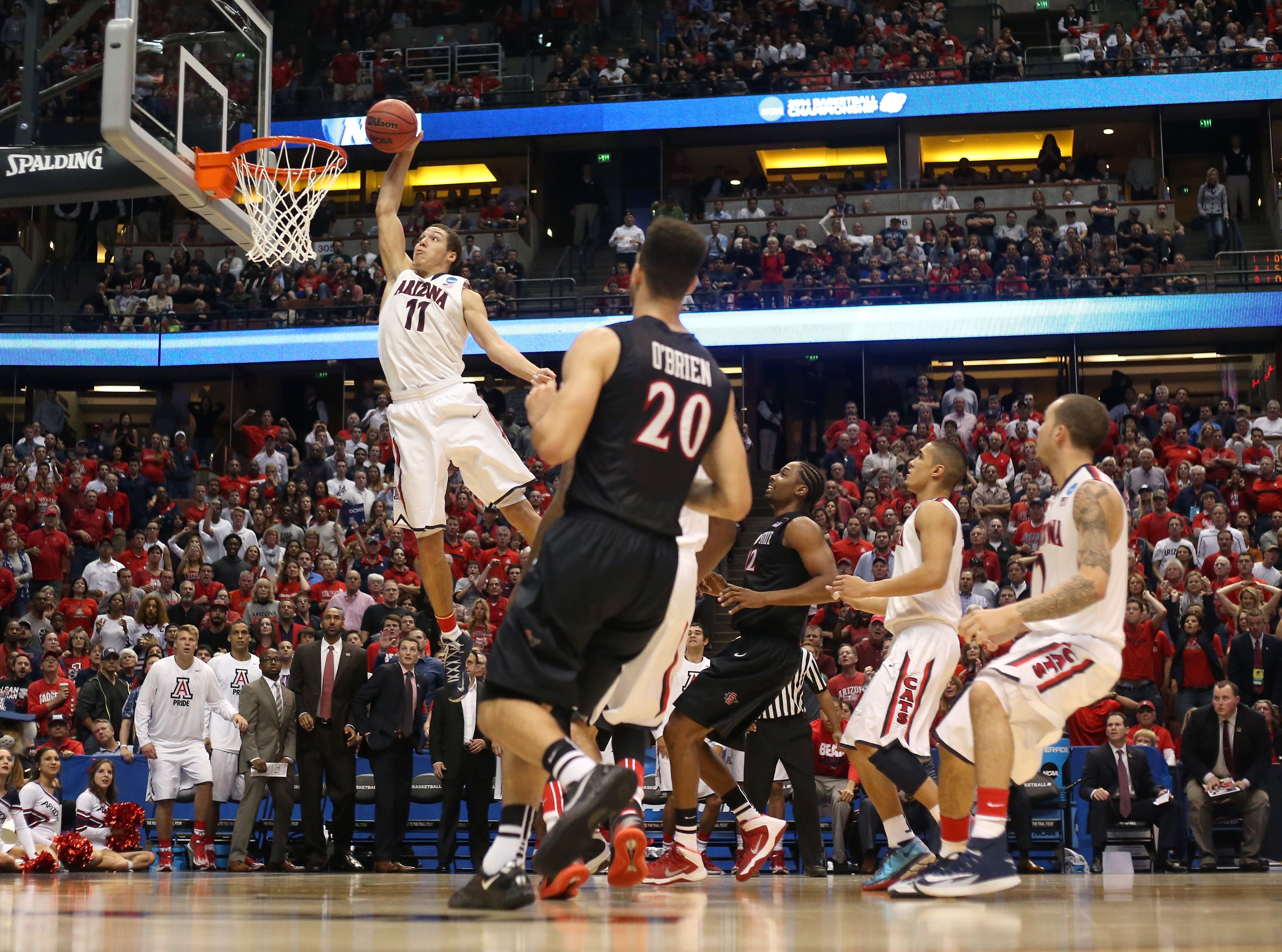 A man jumps toward a dunk.