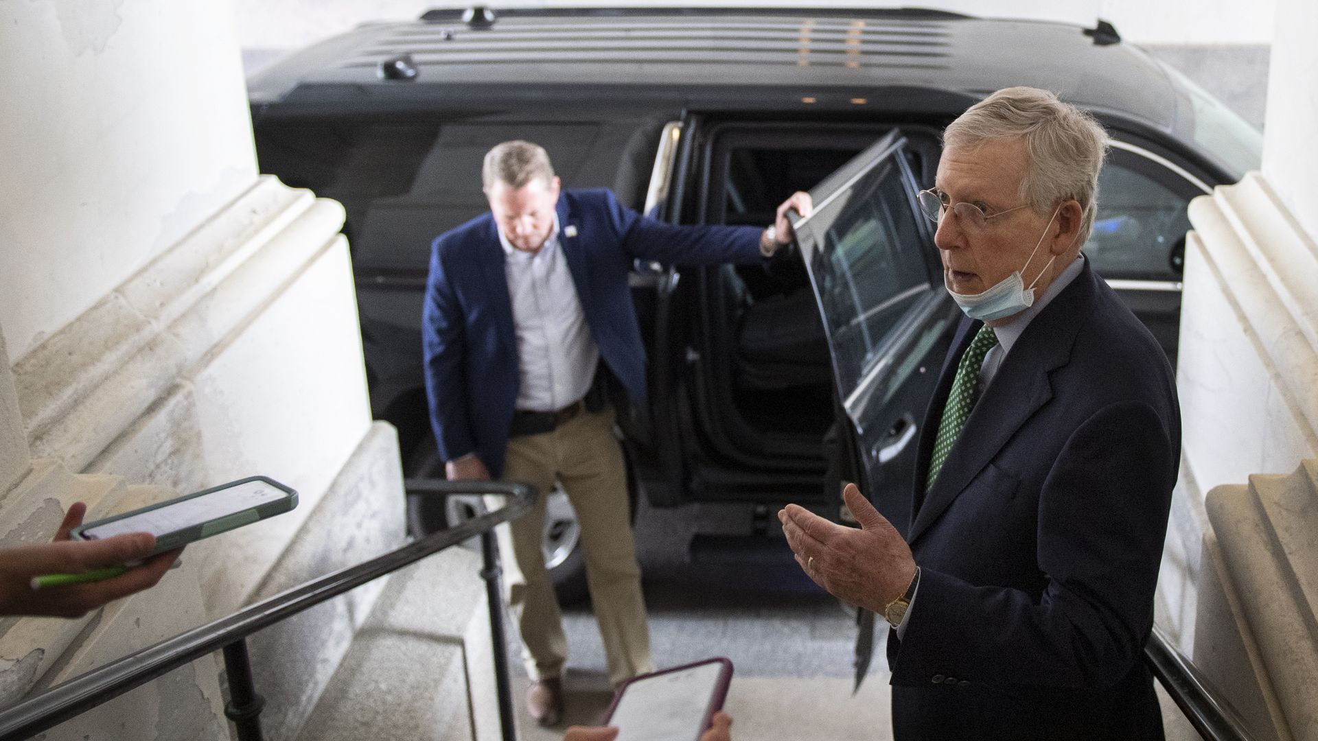 Senate Majority Leader Mitch McConnell, R-Ky., wears a face mask while talking to reporters on Capitol Hill 