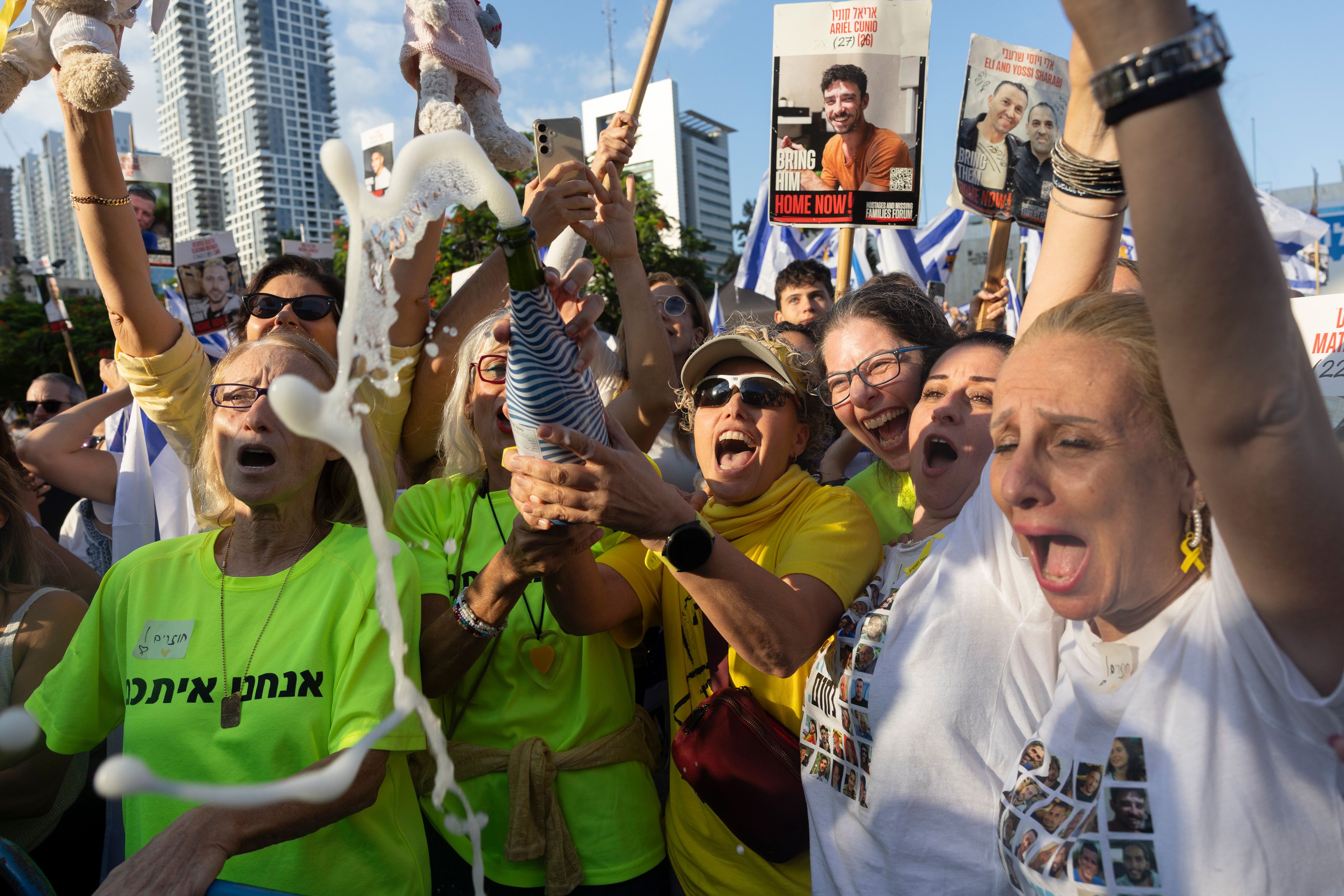 Israelis react as they watch the release of Israeli hostages by Hamas during a live broadcast on so-called hostages square in Tel Aviv, Israel, on Monday, Oct. 13, 2025. Hamas freed seven living Israeli hostages from the Gaza Strip on Monday morning, following a US-led deal reached late last week. P